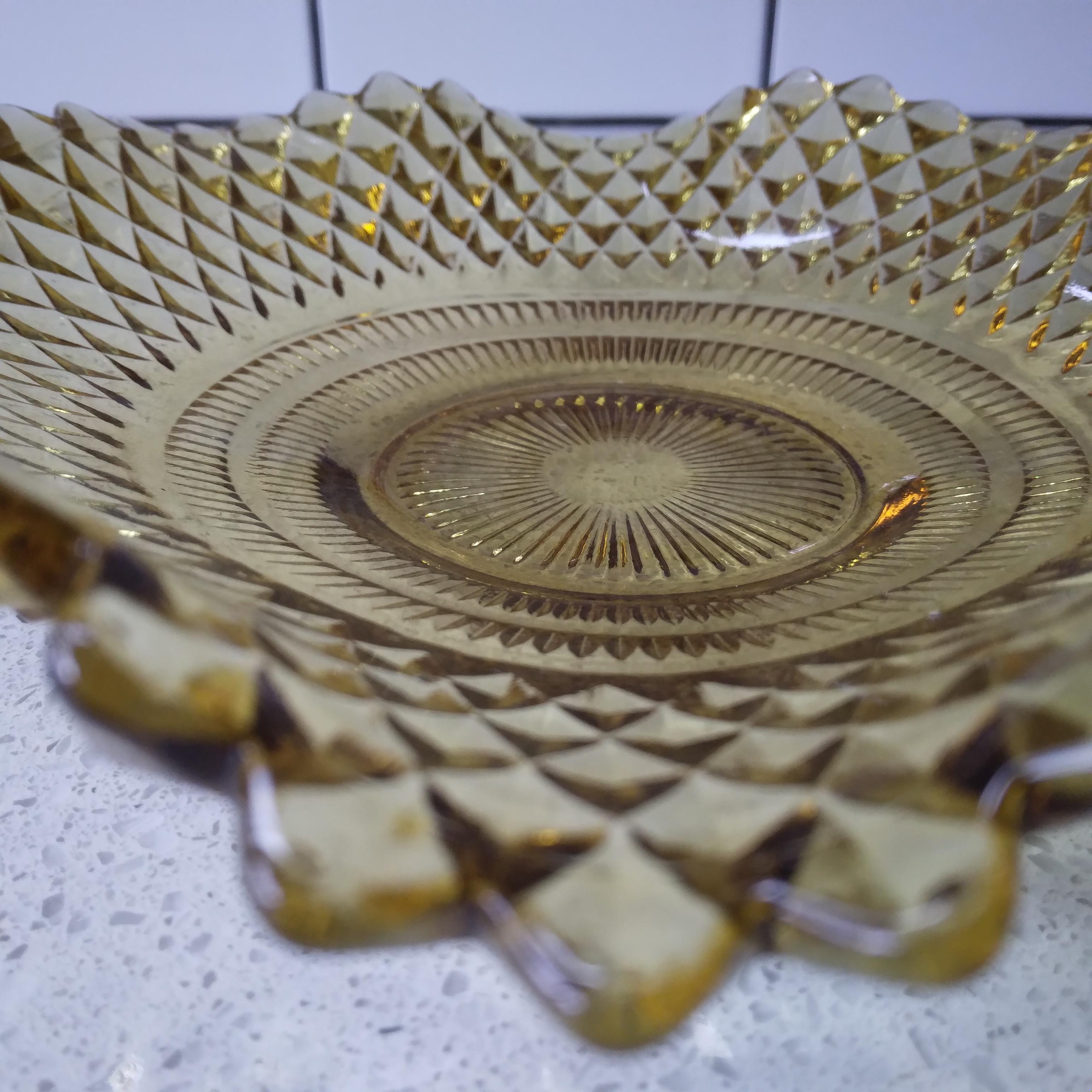 Wavy and translucent... this gorgeous ruffled edge glass platter is simply beautiful. We love the vintage golden amber hue... very retro and warm. The  diamond pattern catches the light perfectly. The thick walled glass is in excellent condition for
