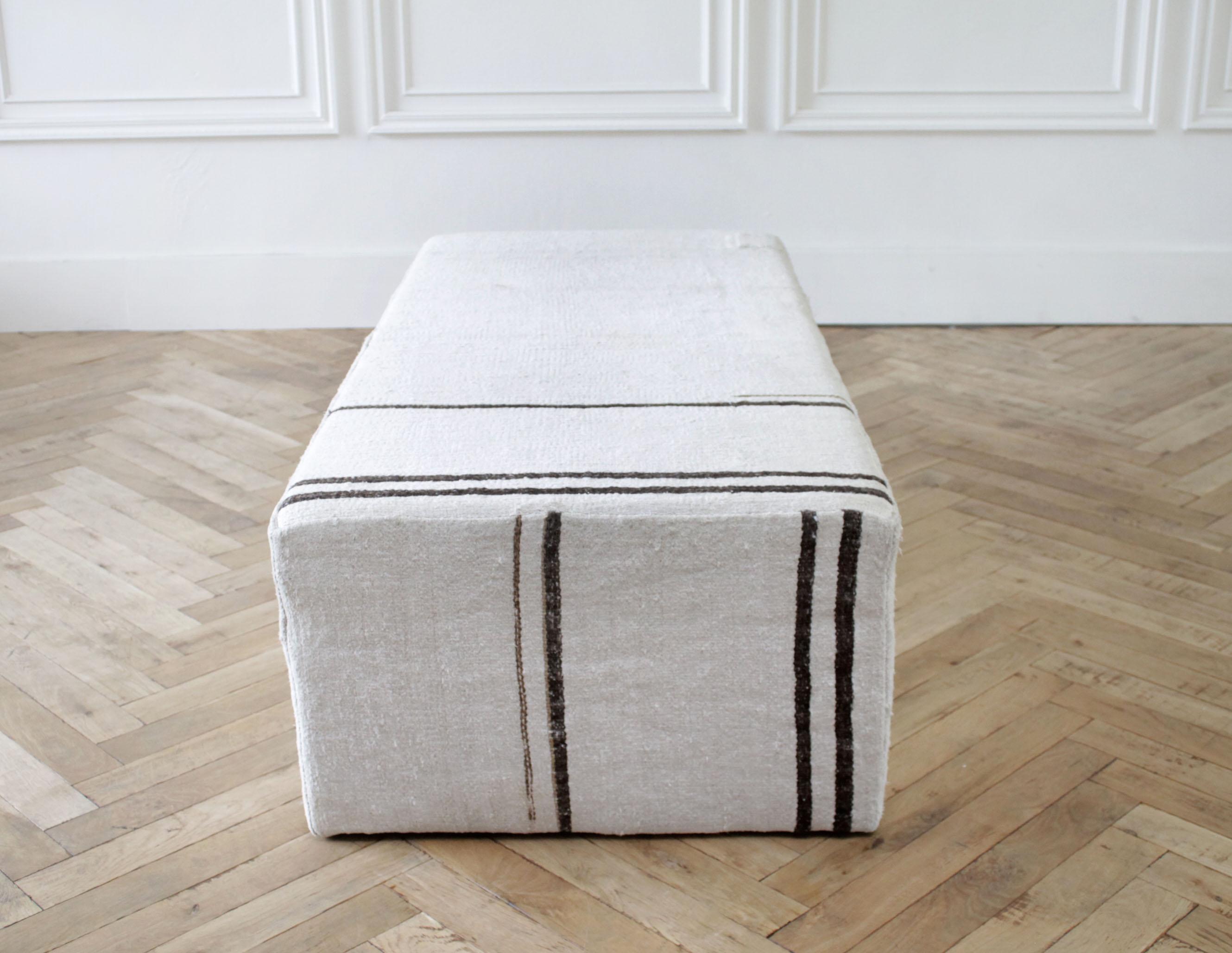 Vintage rug cocktail ottoman with stripes
Made by Full Bloom from a vintage Turkish rug. An off-white background with brown stripes, and original patchwork.
Ottoman has some imperfections, this is made from vintage rugs.

Measures: 60