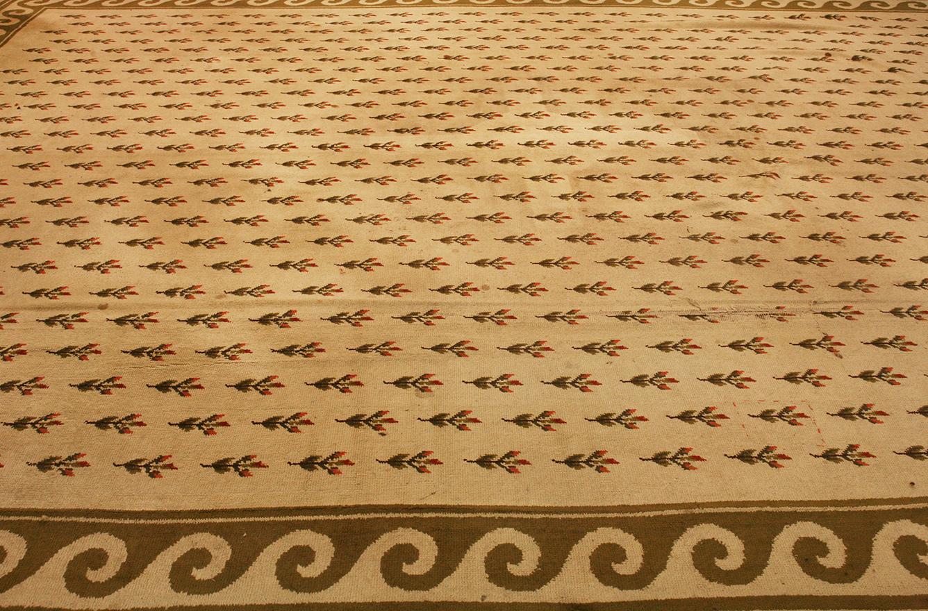This Vintage German Tetex rug, measuring a generous 534 × 384 cm, is a splendid example of timeless elegance and meticulous craftsmanship. The expansive field of the rug is a canvas of delicate beige, adorned with a perfectly repeated pattern of