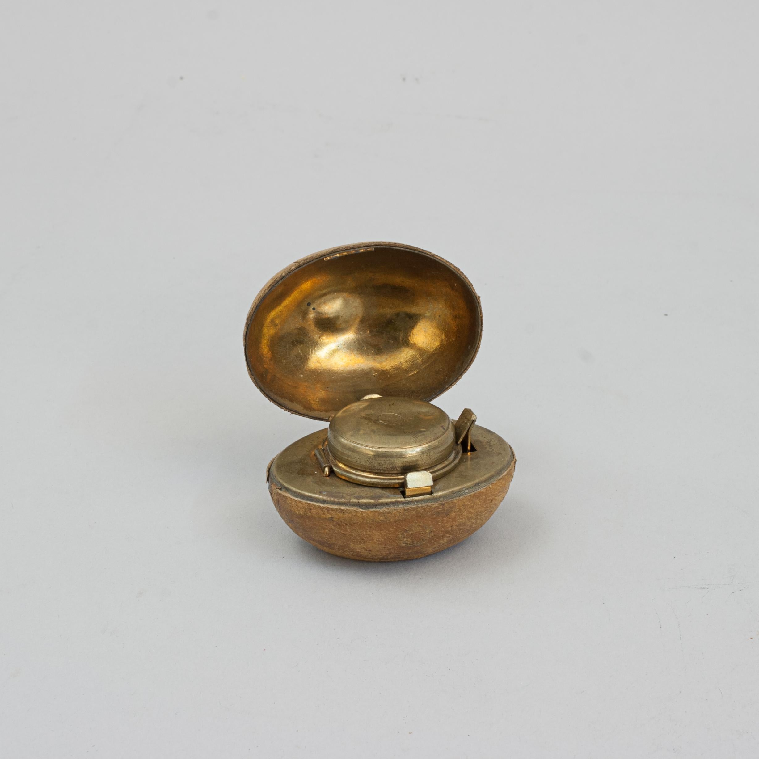 Rare Novelty Rugby Inkwell.
A wonderful leather covered travelling inkwell in the shape of a rugby ball. This is a very desirable, rare and unusual object made from brass and covered in imprinted leather to imitate a ball. It is hinged in the centre