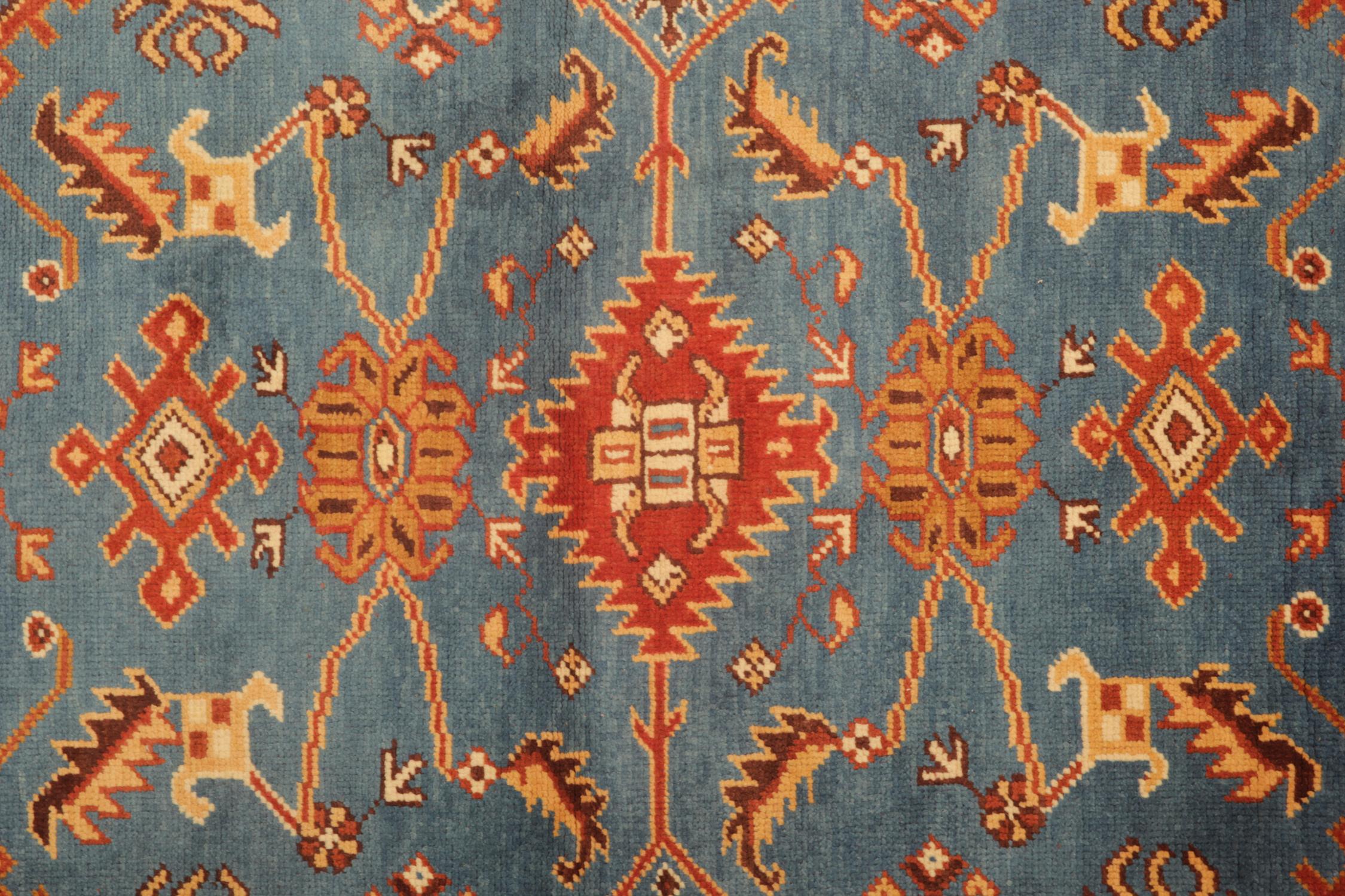This Turkish Oushak Rug features geometric motifs that run through the centre of this blue and red rug. Hand-knotted with vegetable-dyed wool by Turkish rug weavers. Perfect for any modern or traditional home. (Antique Turkish Oushak Area Rug