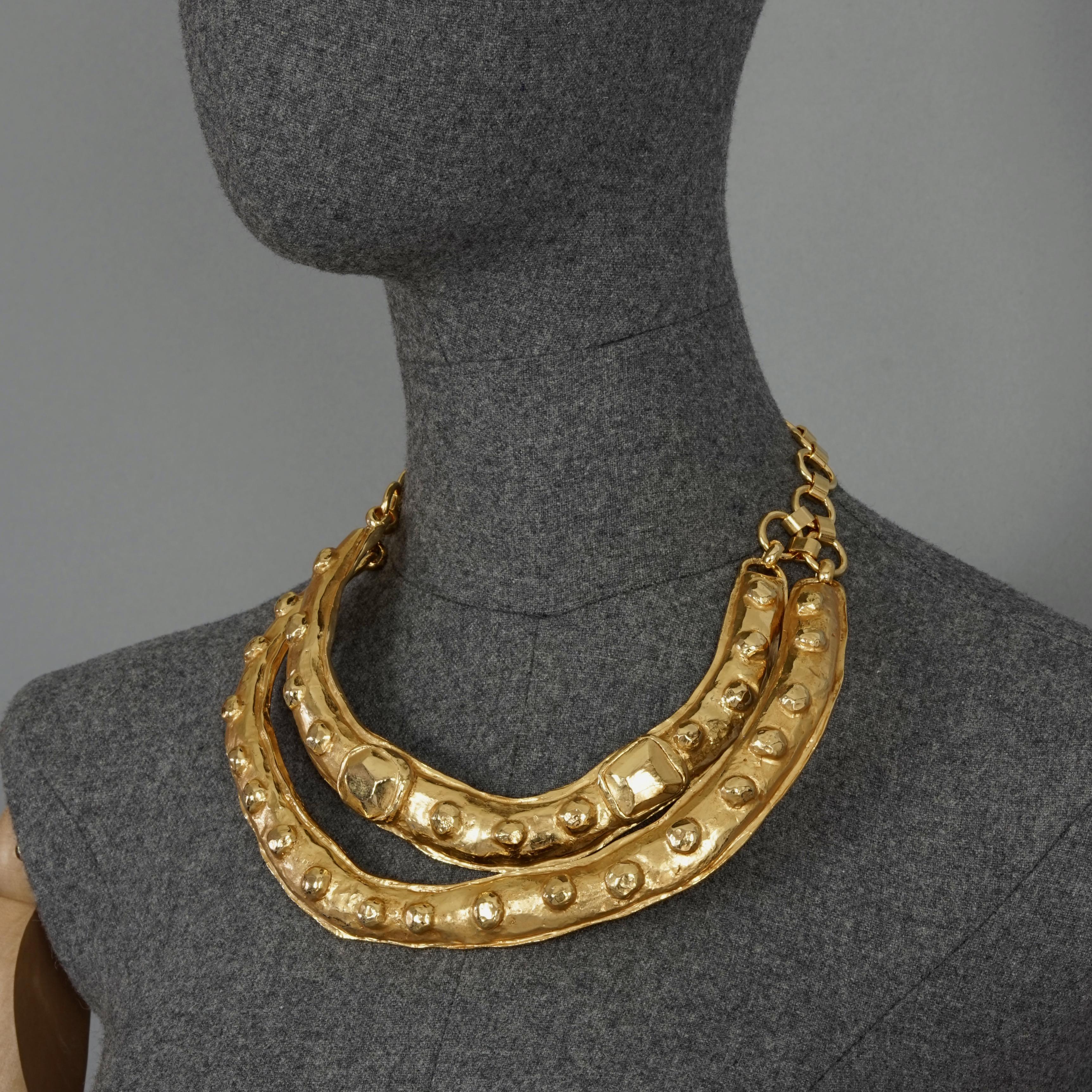 Vintage Runway CHRISTIAN LACROIX Double Layer Masai Rigid Necklace

Measurements:
Adjustable Wearable Length: 13.86 inches (35.2 cm) maximum

Features:
- 100% Authentic CHRISTIAN LACROIX.
- 2 layer textured rigid necklace.
- Each layer is textured