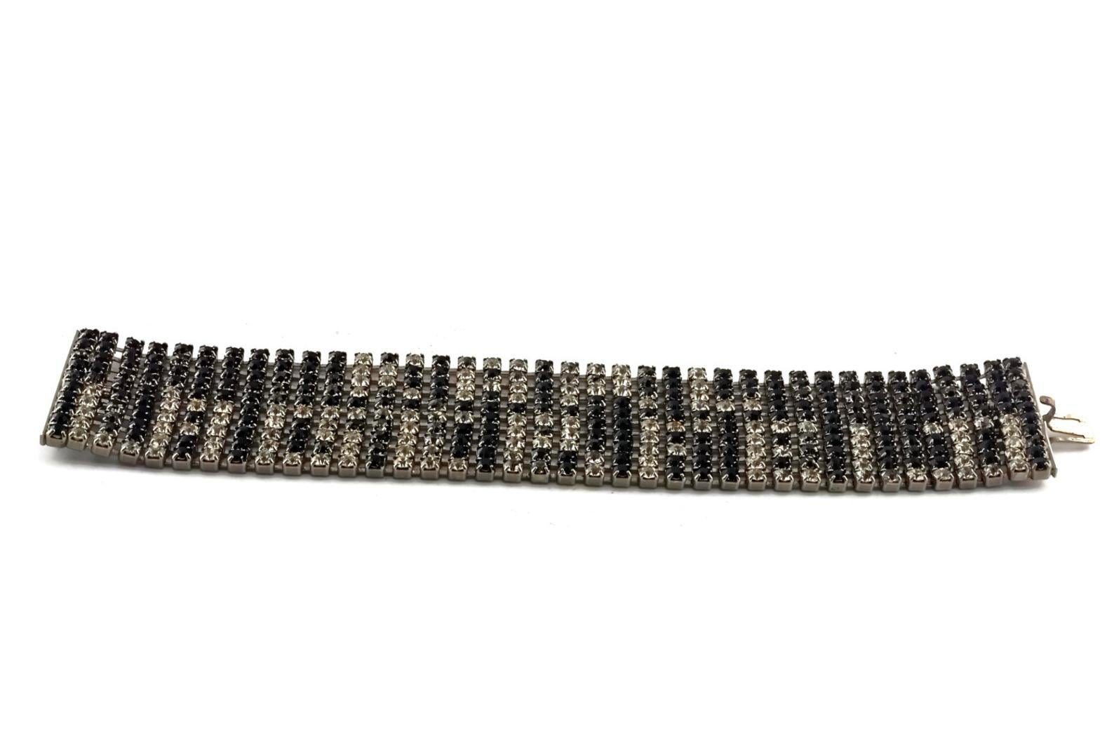 Vintage Runway KARL LAGERFELD Spelled Rhinestones Mesh Bracelet

Measurements:
Height: 1 4/8 inches
Wearable Length: 7 4/8 inches

Features:
- 100% Authentic KARL LAGERFELD.
- Spelled KARL LAGERFELD in black and clear mesh rhinestones.
- Silver