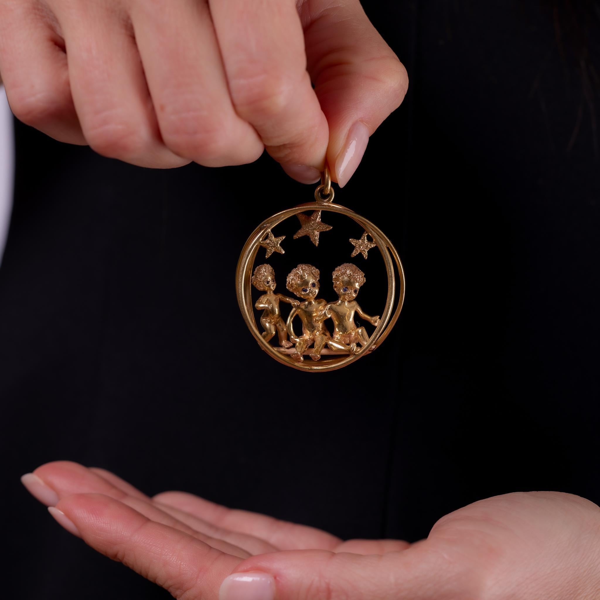 Crafted in the 1970s, this vintage pendant by Ruser is designed in richly textured 14k yellow gold and set with 6 round cut sapphires totaling approximately .05 carats. Known for their playful and sculptural designs, Ruser’s craftsmanship is evident