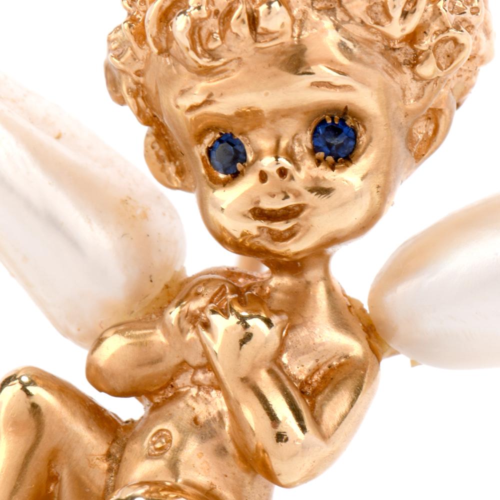 This Vintage Ruser sweet angel Child is made of 14k yellow gold and genuine pearls.
Its' gold body is smooth throughout with texture and detail in the hair.  His wing is made of genuine pearls and he is sitting on cloud made of genuine