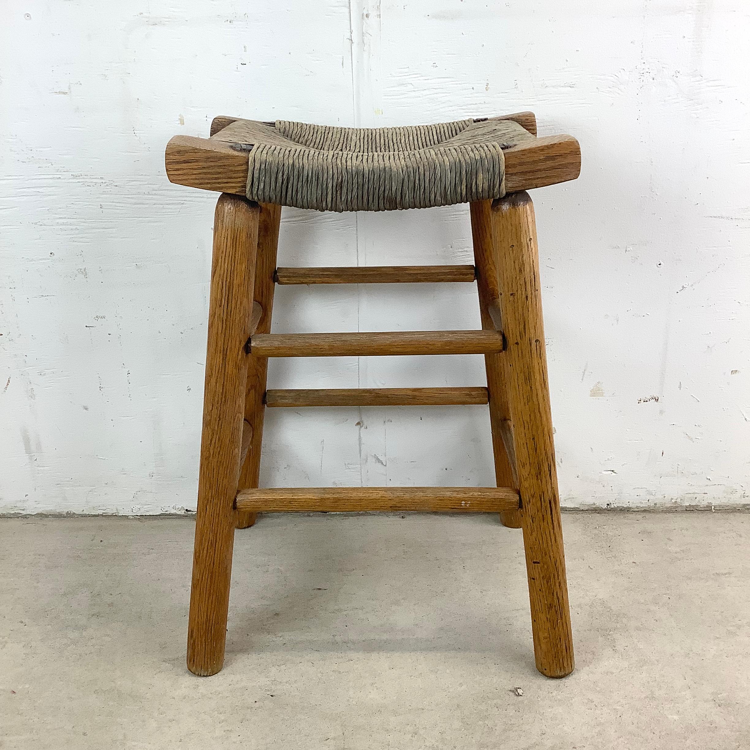 A blend of rustic charm and Nordic restraint, this vintage counter stool with a woven rush seat embodies the easy elegance of Danish design. Its solid wood frame features a warm, natural finish that highlights the grain, while the handwoven seat