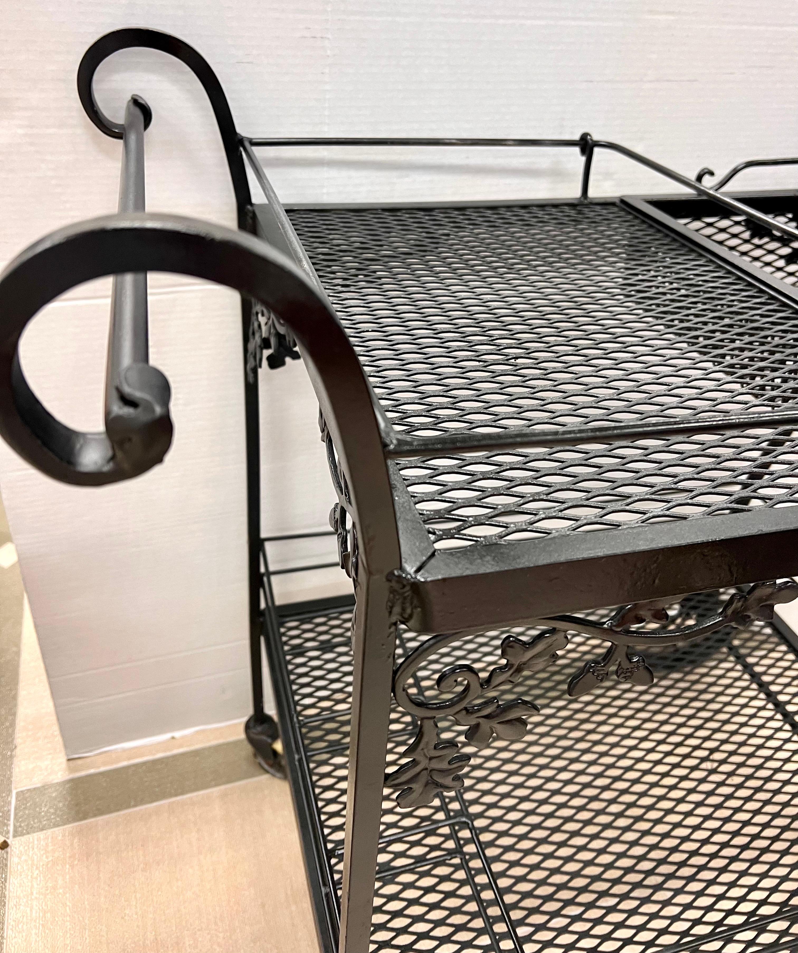 Vintage black iron rolling serving bar cart by Russell Woodard with removable tray.
