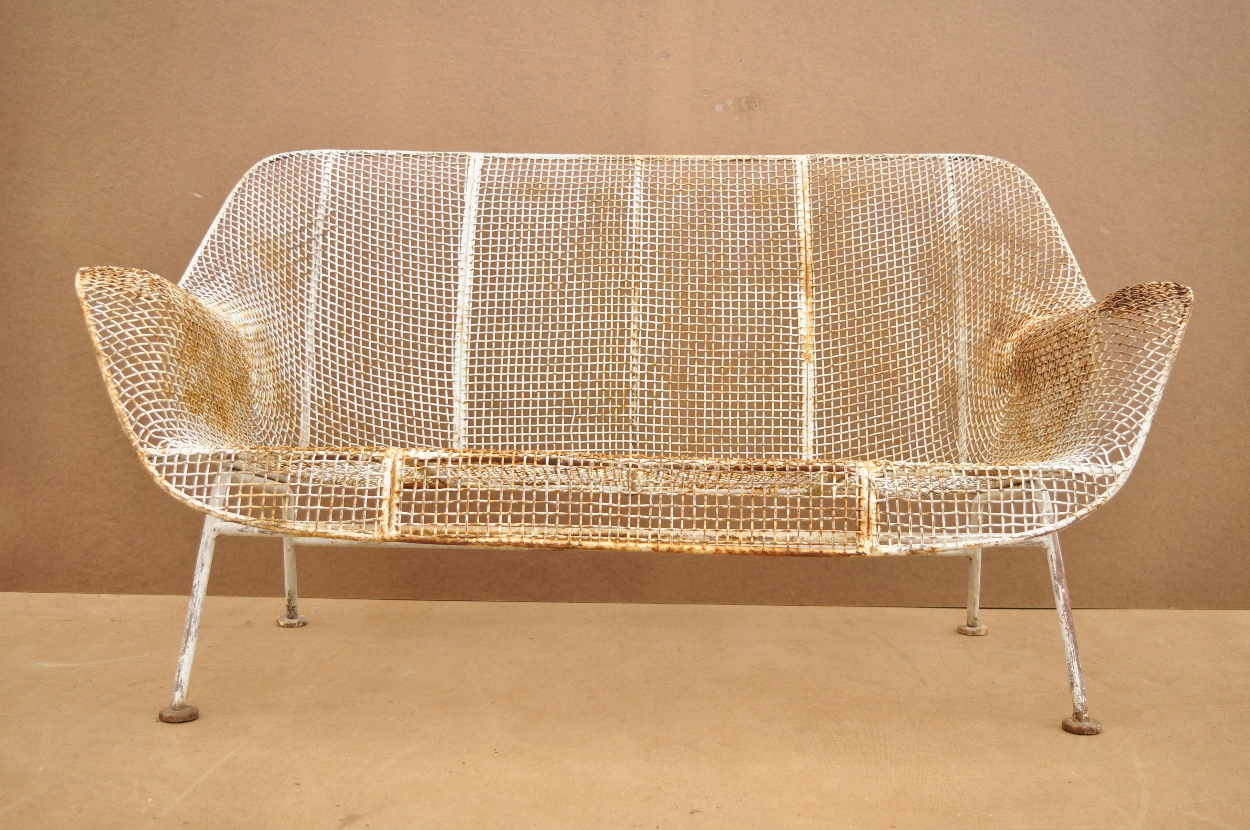 Vintage Russell Woodard Sculptura metal mesh wrought iron loveseat sofa. Item features iron frame, metal mesh seats, iconic Mid-Century Modern design, very nice vintage item, circa 1950. Measurements: 28