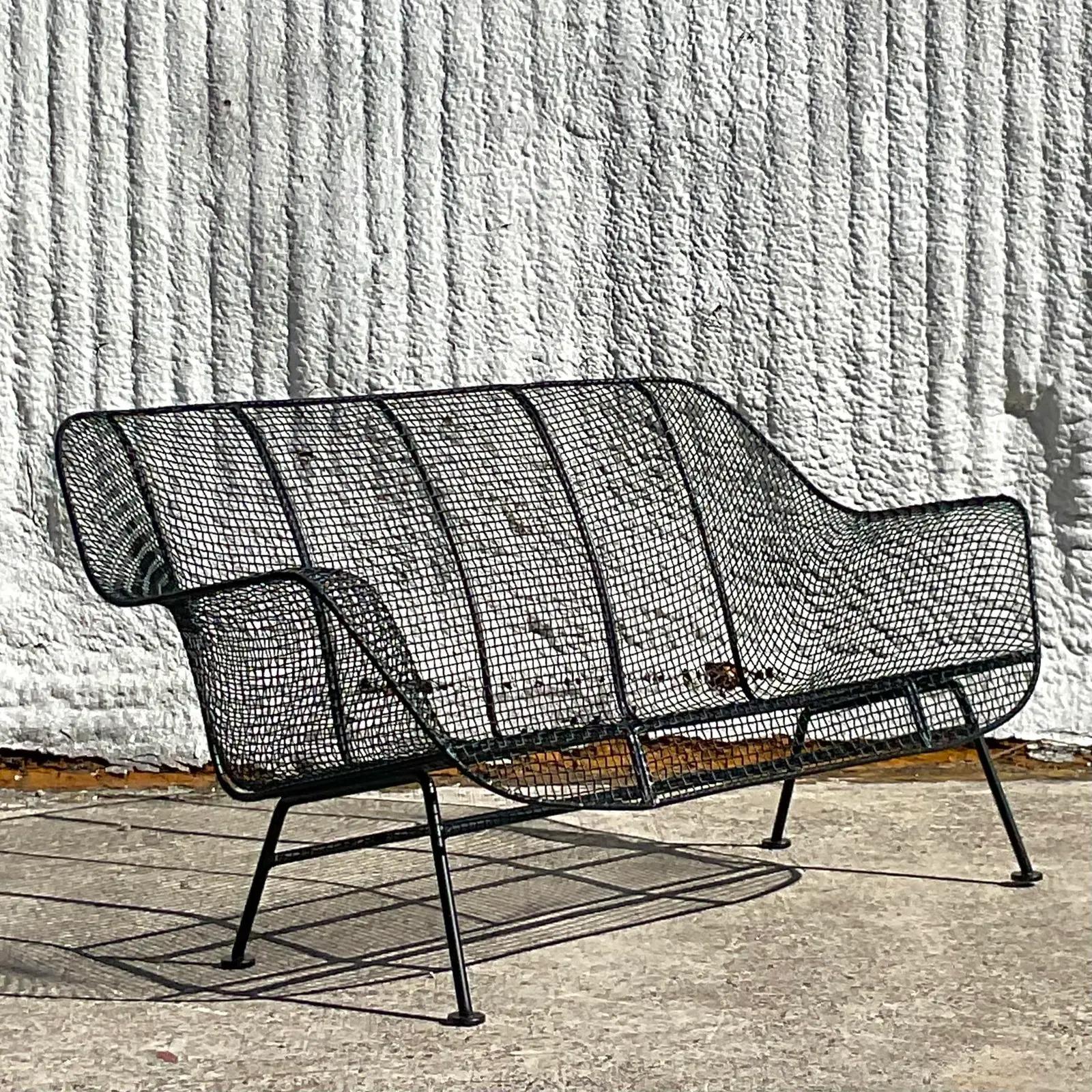 A fantastic vintage MCM wrought iron loveseat. Made by the iconic Russell Woodard group. Unmarked. Part of the coveted “Sculptura” collection. Fully restored with all new powder coating in matte black. Acquired from a Palm Beach estate.