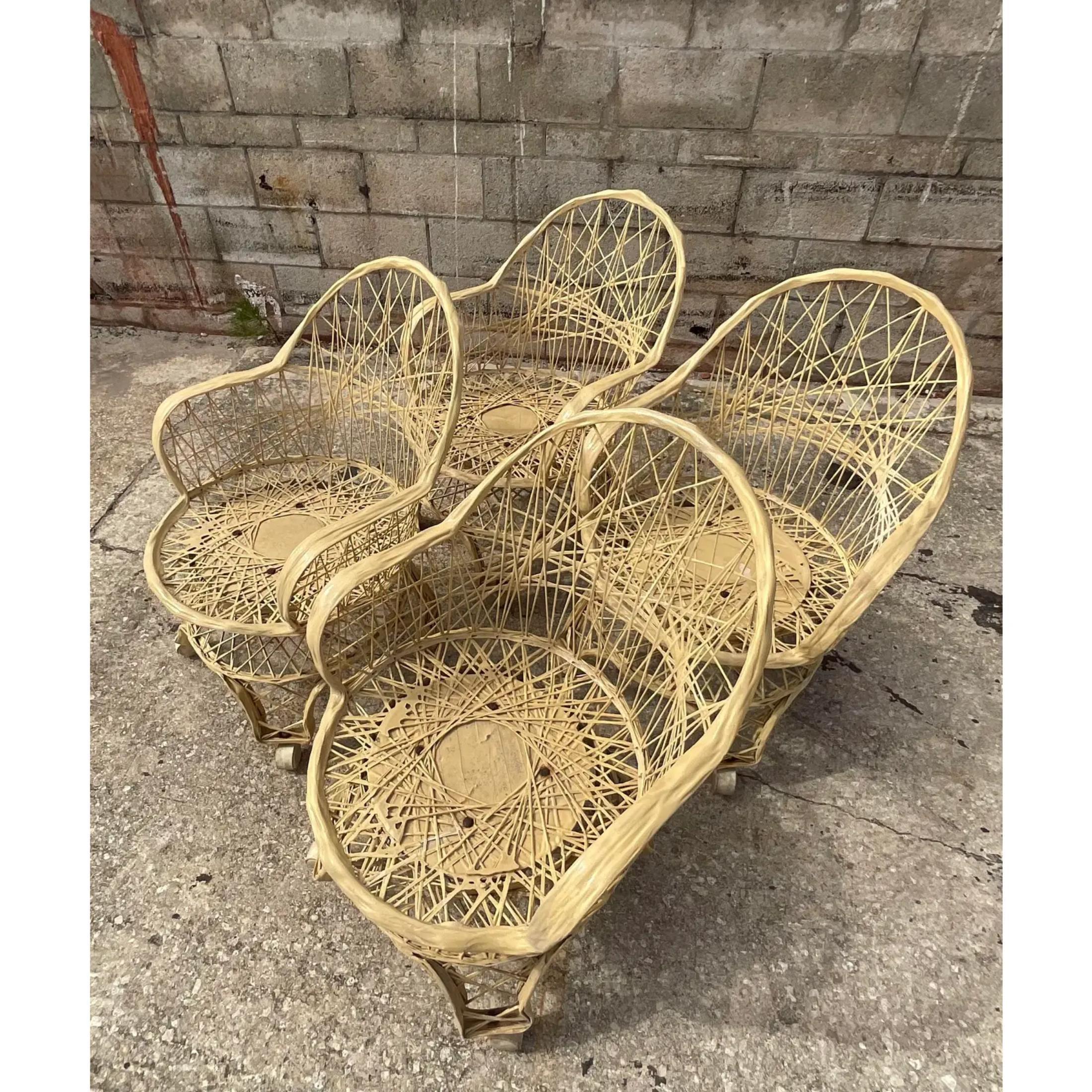 A fab set of four Russell Woodard dining chairs. Done in the iconic spun fiberglass web design. The chairs are the coveted Eiffel Tower base on casters. Acquired from a Palm Beach estate