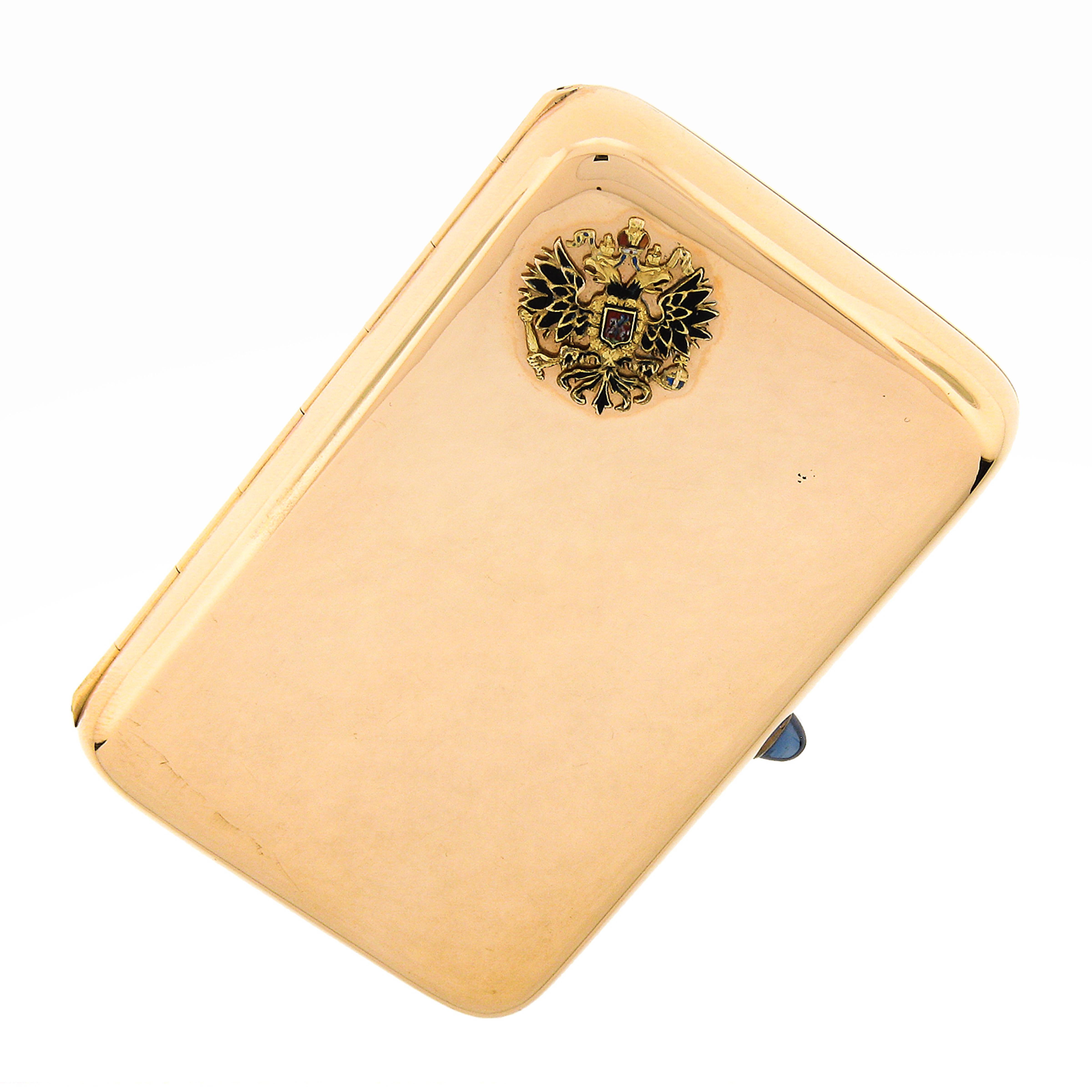 This incredibly well crafted vintage cigarette gold box was crafted in Russia from solid 14k rosy yellow gold and features a large compartment which is revealed by lifting the sapphire adorned tab away from the high polished finish case. The front
