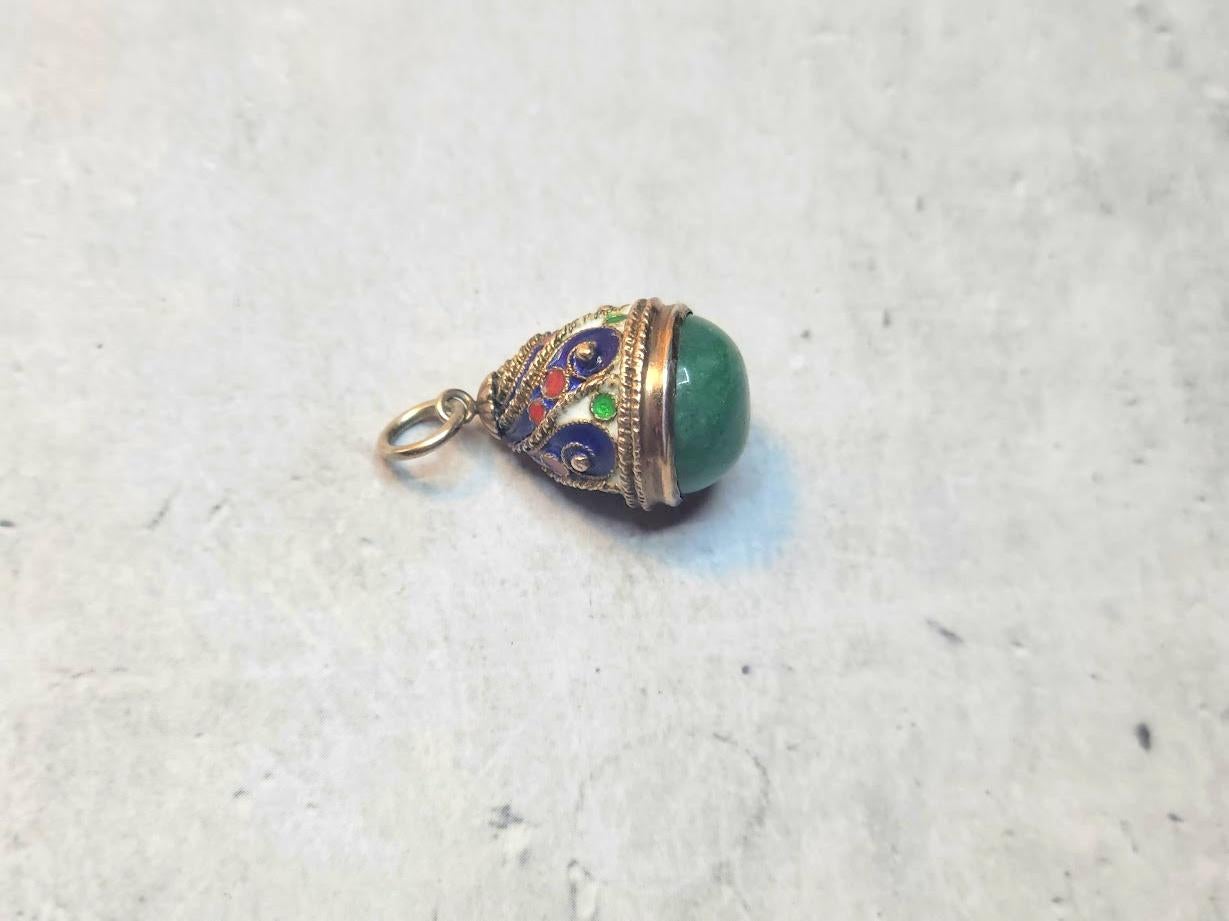 This charming vintage Russian Soviet silver cloisonné enamel egg pendant with natural aventurine reminiscent of Medieval Russian craftsmanship. Dating back to the Soviet period, it is a rare find from the 20th century.

Dimensions:
Height (excluding