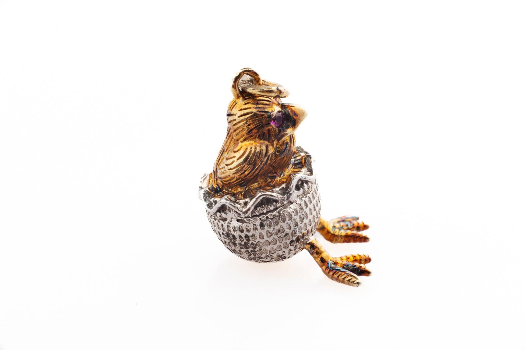 
A Silver and Silver Gold Gilt Russian Easter Egg Charm or Pendant is cute as a chick can be. Some think he looks grumpy. After all he just pushed himself through his egg, no easy task. I see a slight smile of success. The chick has shining ruby