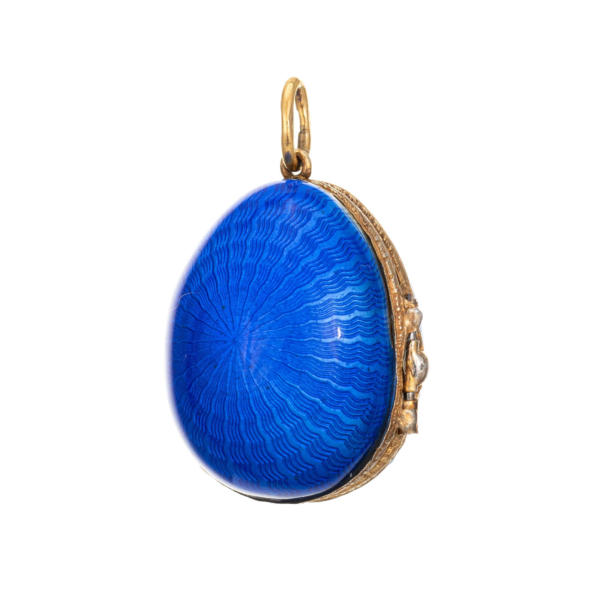 Finely detailed vintage Russian enameled egg crafted in sterling silver (gilt).   

8 old rose cut diamonds total an estimated 0.05 carats (estimated at I-J color and SI2 clarity). The egg opens to reveal two sapphires, a pearl and emerald. The egg