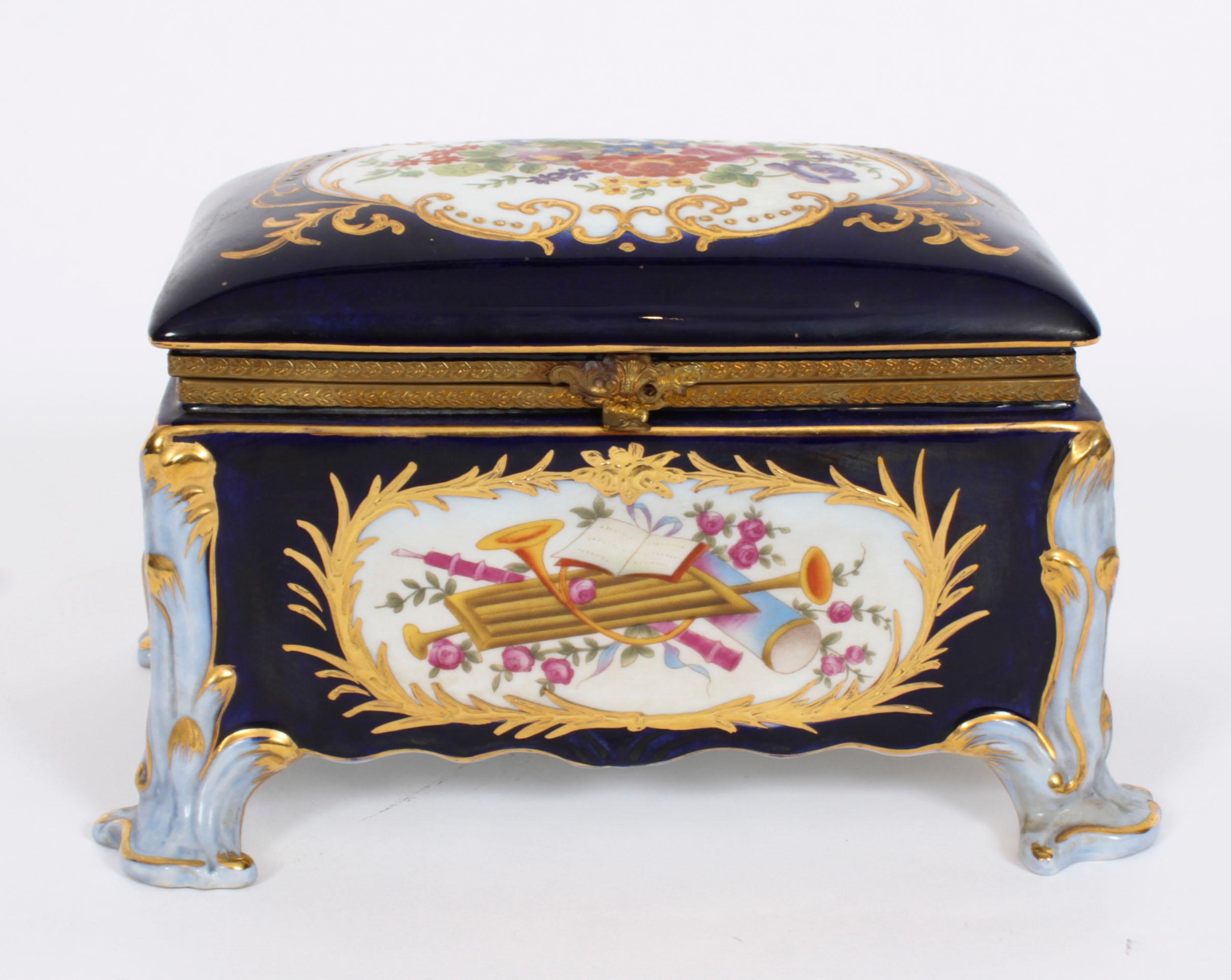 A stunning vintage porcelain and ormolu mounted jewellery casket in the Imperial Russian manner, dating from the last quarter of the 20th century.

This beautiful piece is hand-painted in a classic royal blue and is further adorned with musical