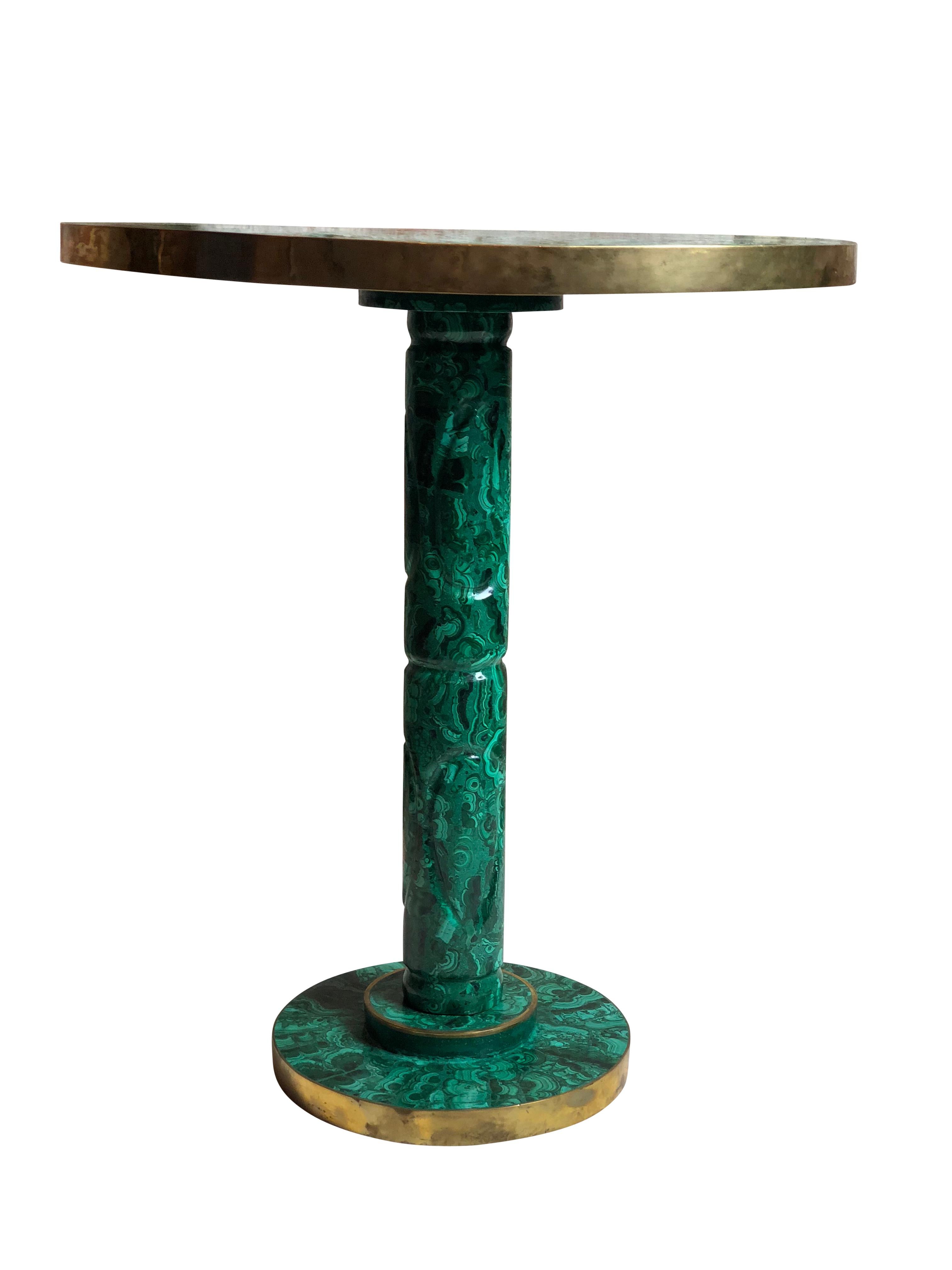 A vintage Russian malachite side or occasional table

Having malachite throughout the table including under the base and under the circular top table area, with a polished brass rim along the border of the table

Dimensions: Height: 20.5