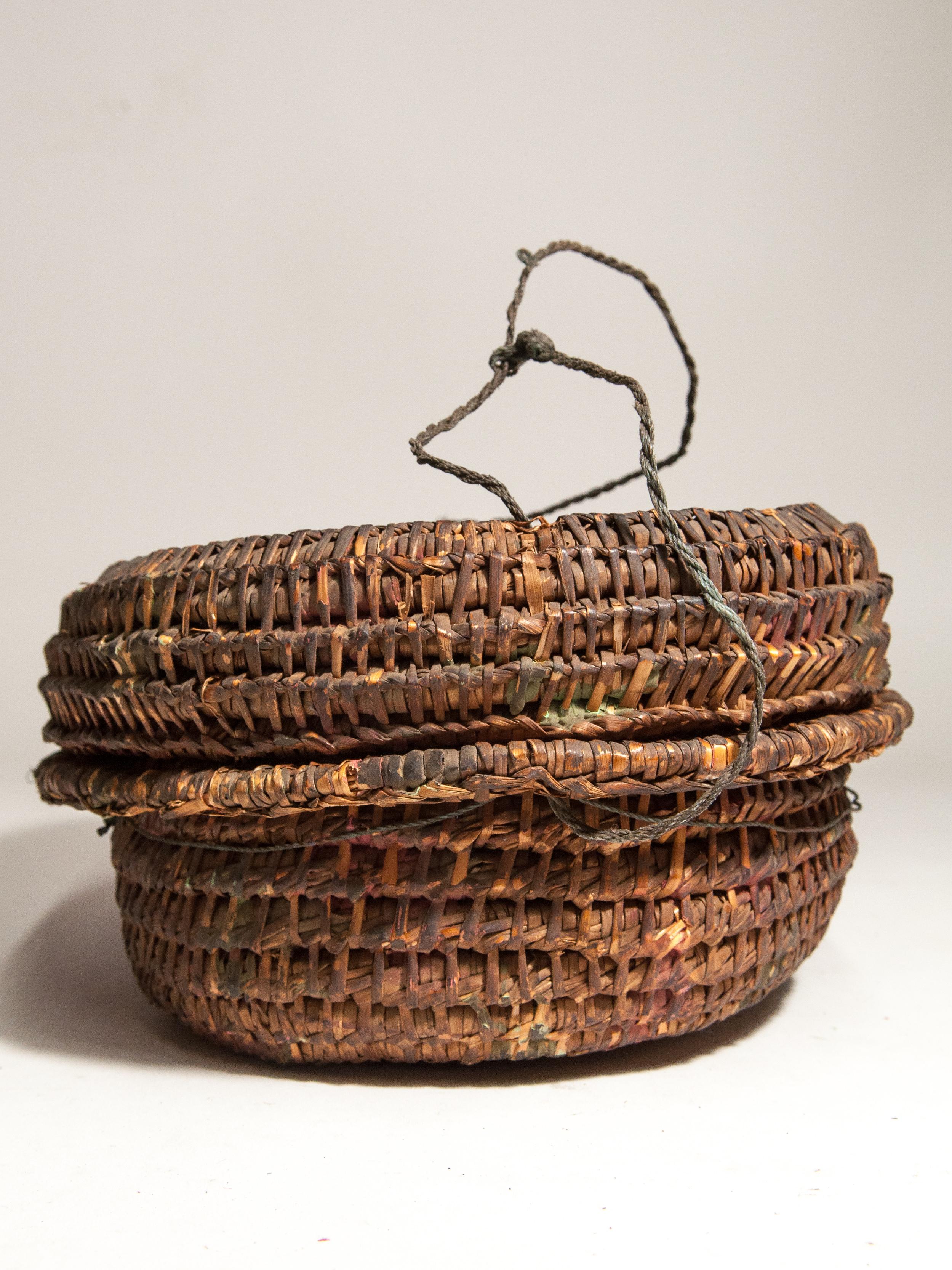Vintage rustic basket box from the Tharu of Nepal, mid-20th century.
This extremely rustic bamboo basket box is from the Tharu of southern Nepal. It would have been used to hold anything from knick-knacks to valuables in a simple rural home. Woven