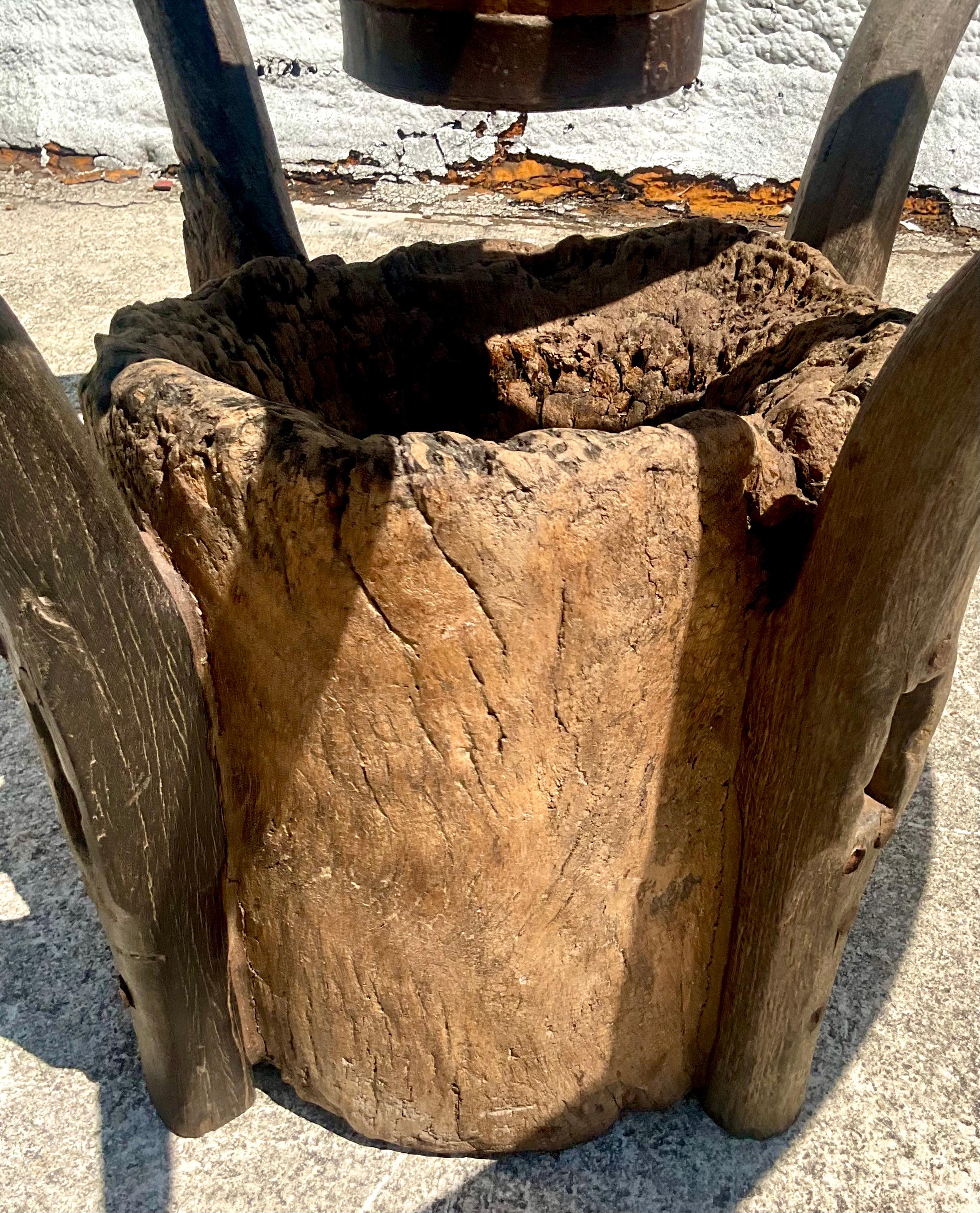 Amazing vintage rustic custom built table and benches. A fabulous vintage wagon wheel with an inset glass top. Sits in a metal frame attached to a heavy vintage tree trunk. Four custom built benches wrap around the table. Unusual and exciting. A