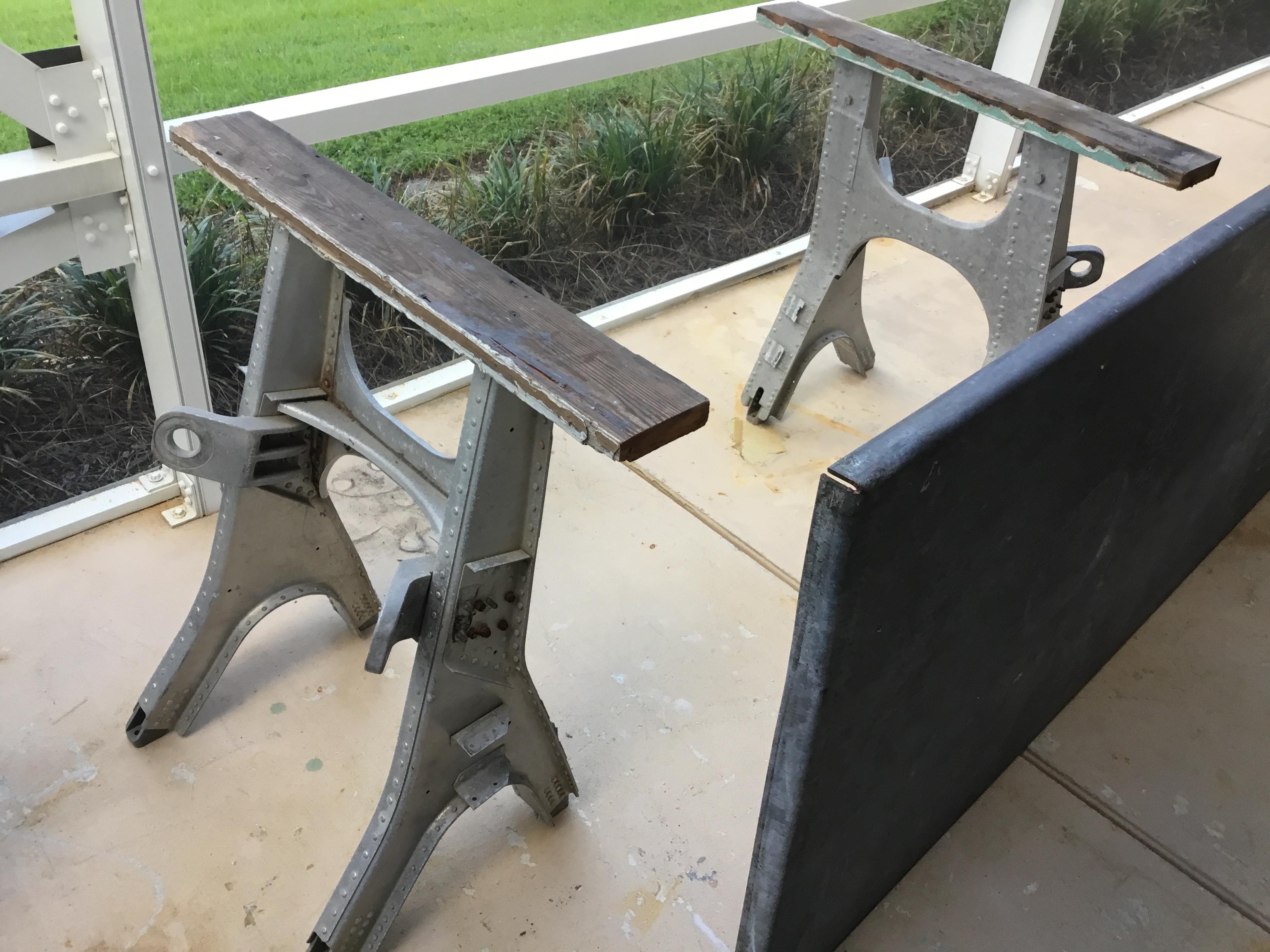 One of a kind industrial work table made of two support bases made of galvanized steel originally American made as airplanes repair engine holder, the top of the table made of 0.25 thick galvanize steel that set on the two engine holder to make a