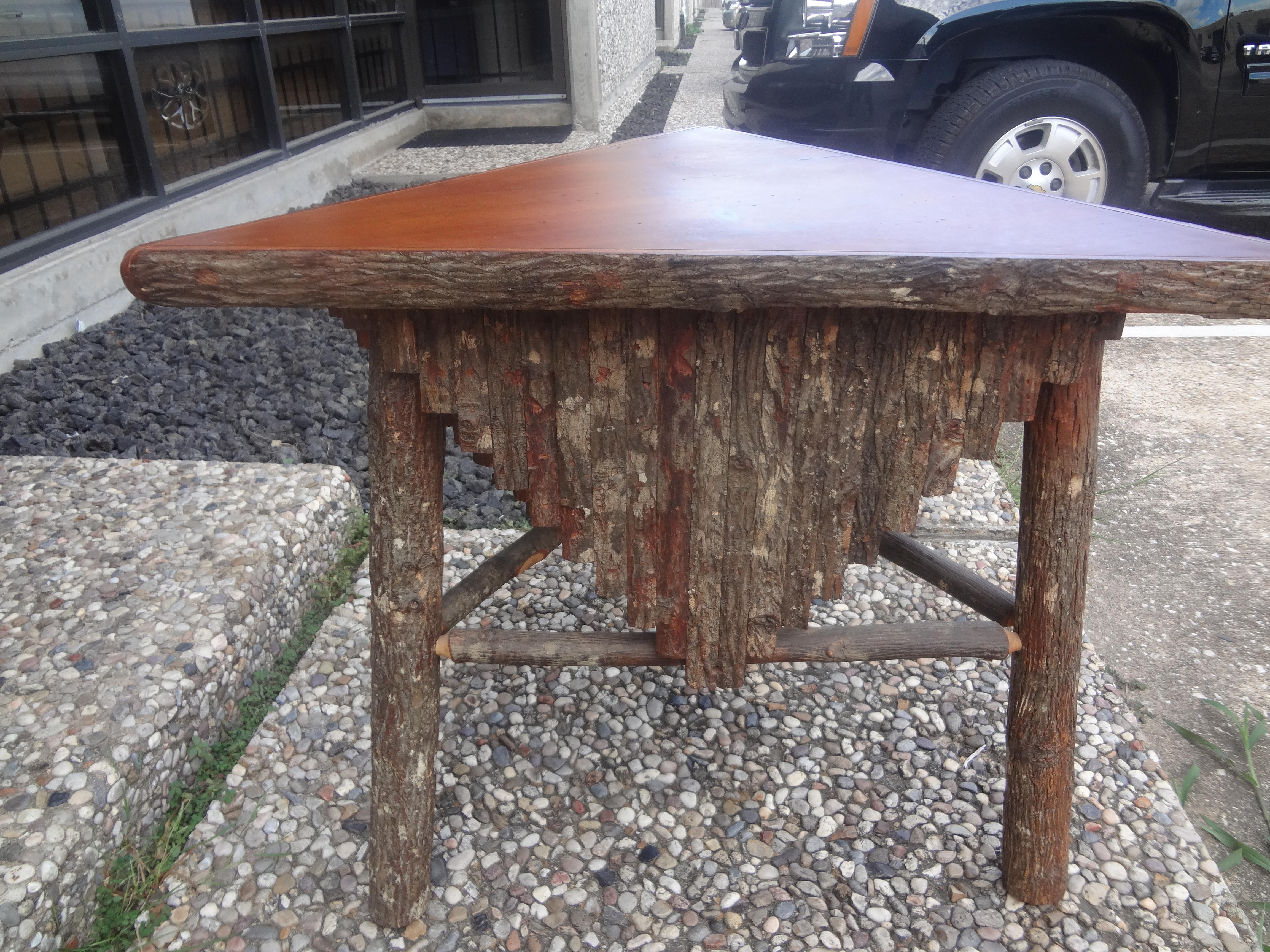 Vintage Rustic Log and Bark Table.
This stunning rustic or primitive triangular table is artisan made of logs and tree bark. 
This handsome table would work well in a rustic or primitive interior, a ranch, farm or lake house.
Beautifully crafted,
