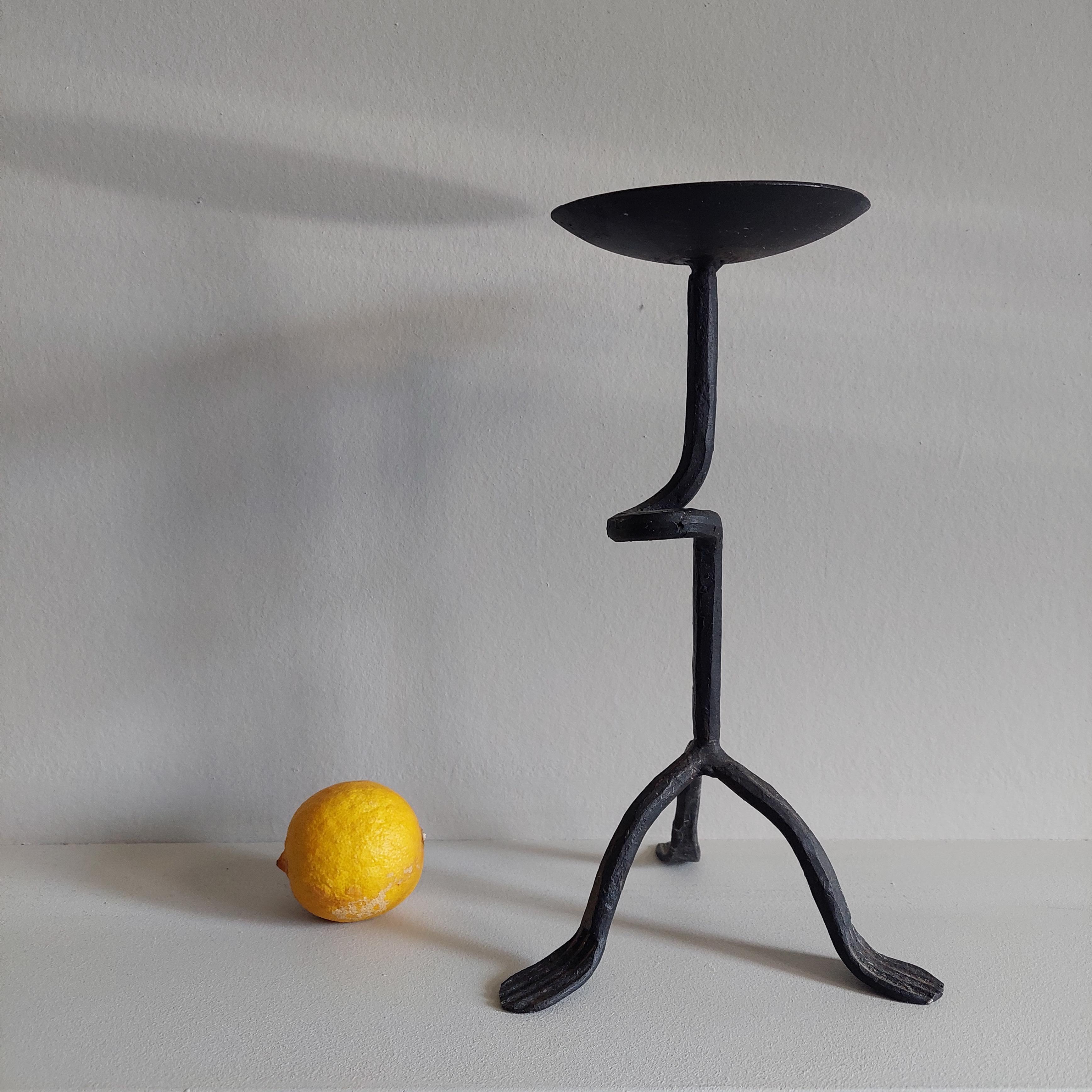 Rustic black wrought iron candle stick holder from France

This is a rare shaped wrought iron tripod candlestick...dating most probably from the mid century, 1950s
Vintage Rustic candle stick holder with a simple looped stem. 
This vintage