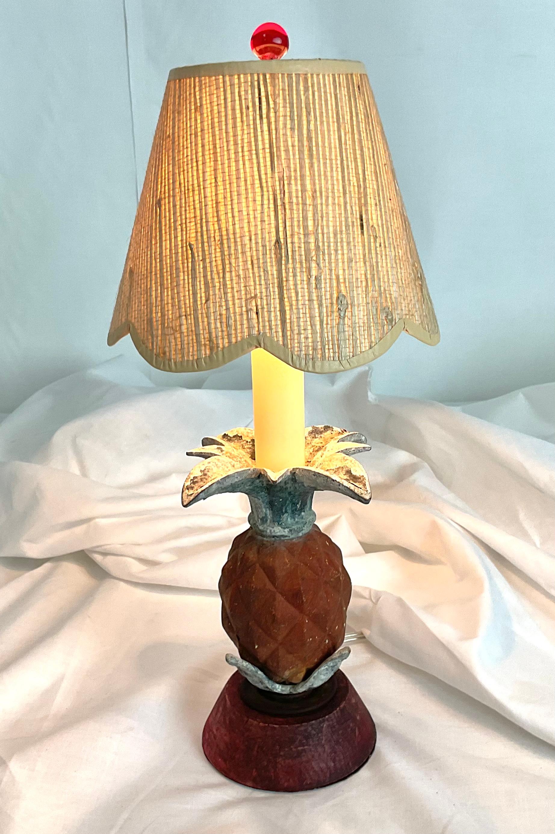 Add a touch of tropical charm to your space with this delightful vintage pineapple table lamp. Featuring a carved pineapple form base in warm tones of russet and gold, accented by aged silver leaves, the piece blends whimsy and sophistication. The