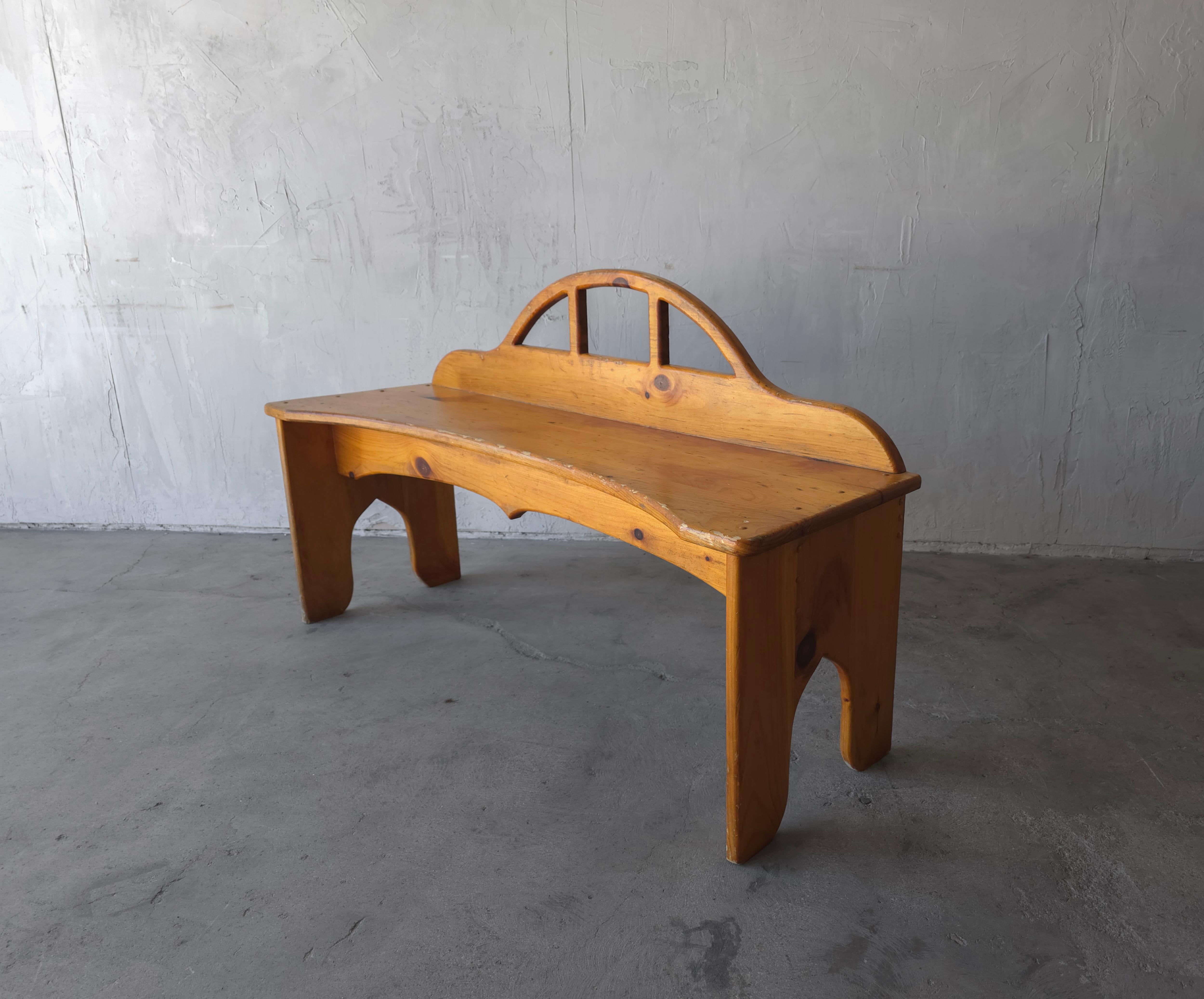 Beautiful handcrafted pine bench.

The bench gives off a very rustic, craftsman style feel, but is so unique, it would mesh in to many decor styles.

It is structurally sound and in good condition overall. There are some marks and wear, from age and