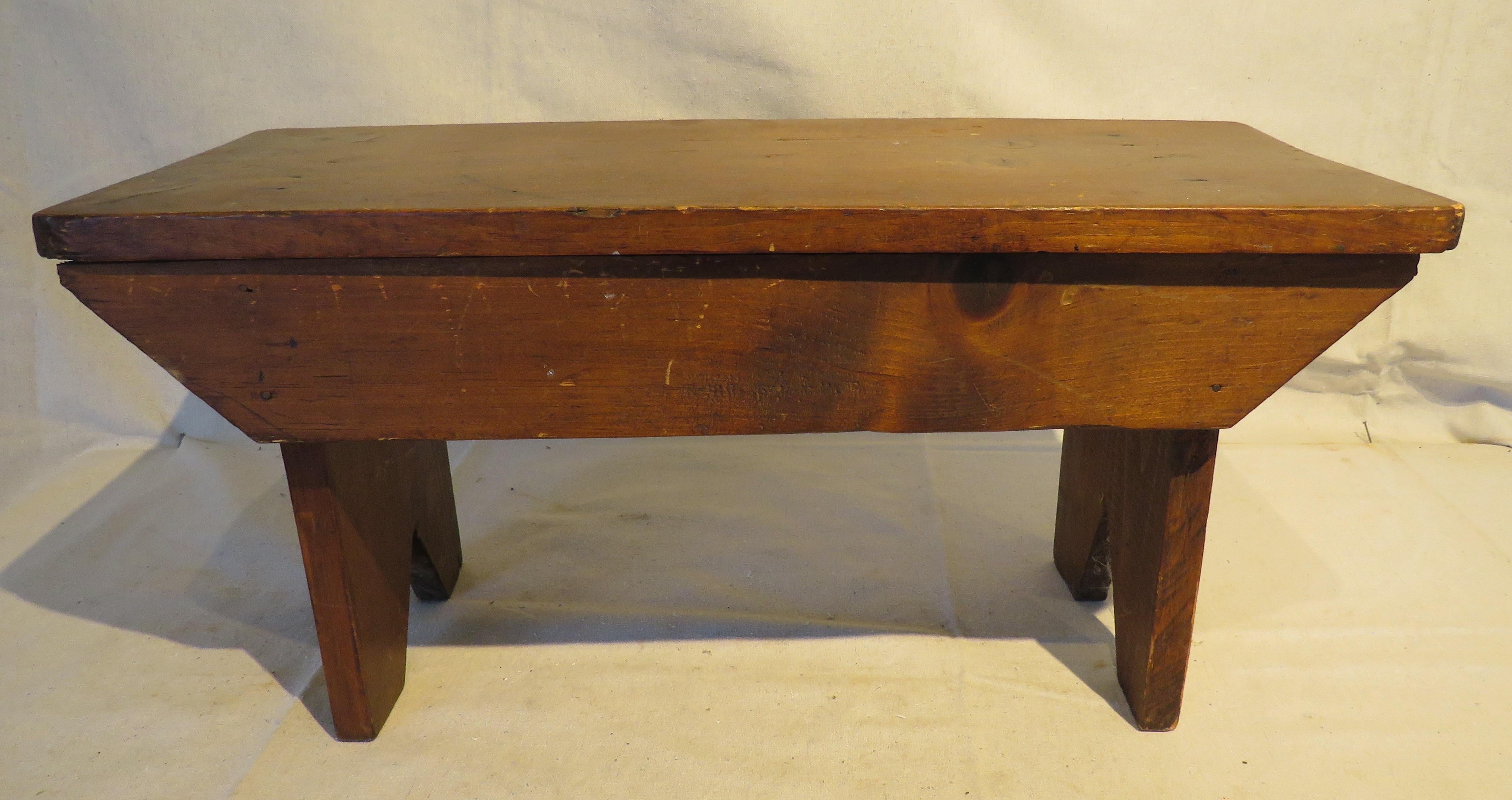 Vintage pine stool with classic, rustic design.