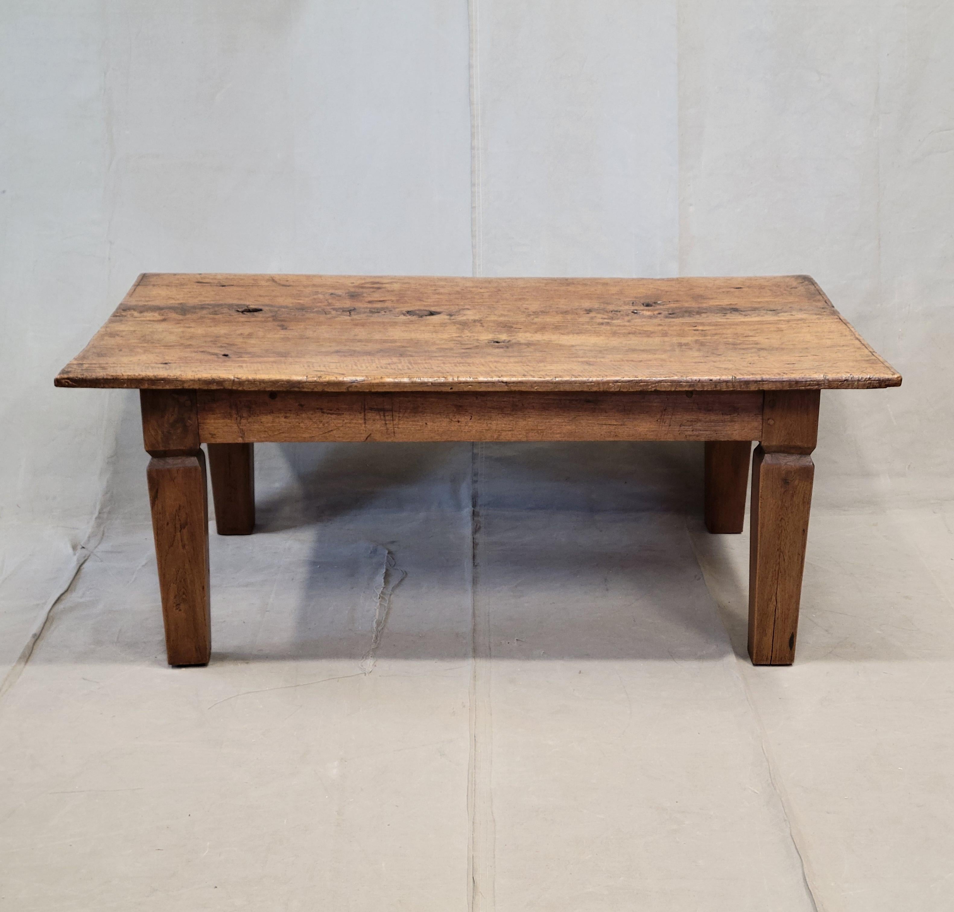 A gorgeous vintage, reclaimed rustic burl teak coffee table imported by the Jason Scott Collection. Crafted in the 1990s out of a beautiful single slab of burl teakwood and attached to a set of teak legs, this stunning piece would add rustic