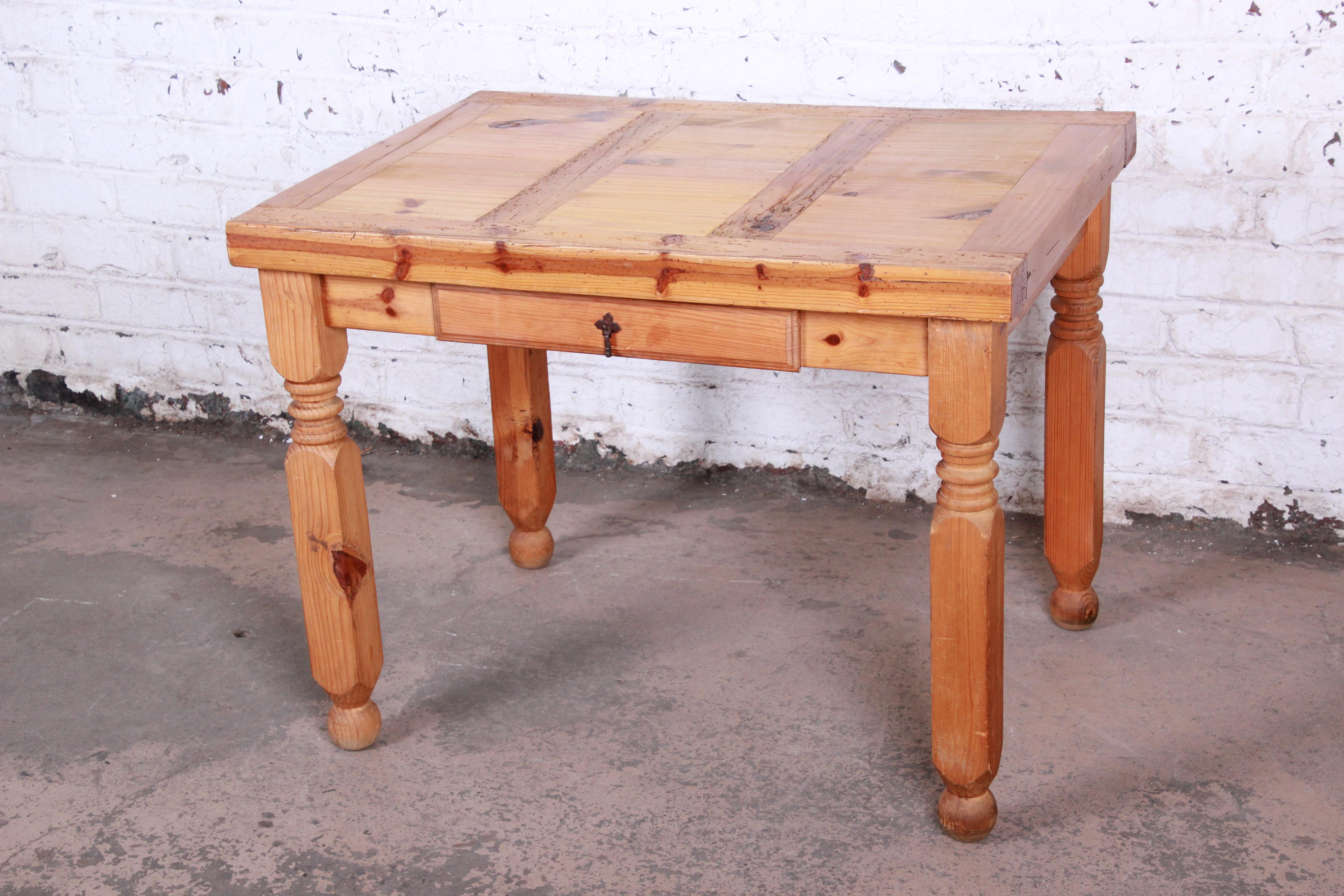 A gorgeous primitive rustic pine writing desk. The desk features solid wood construction and beautiful knotty pine wood grain. It has a single drawer for storage. The desk is finished on all sides. It is in very good original vintage condition.