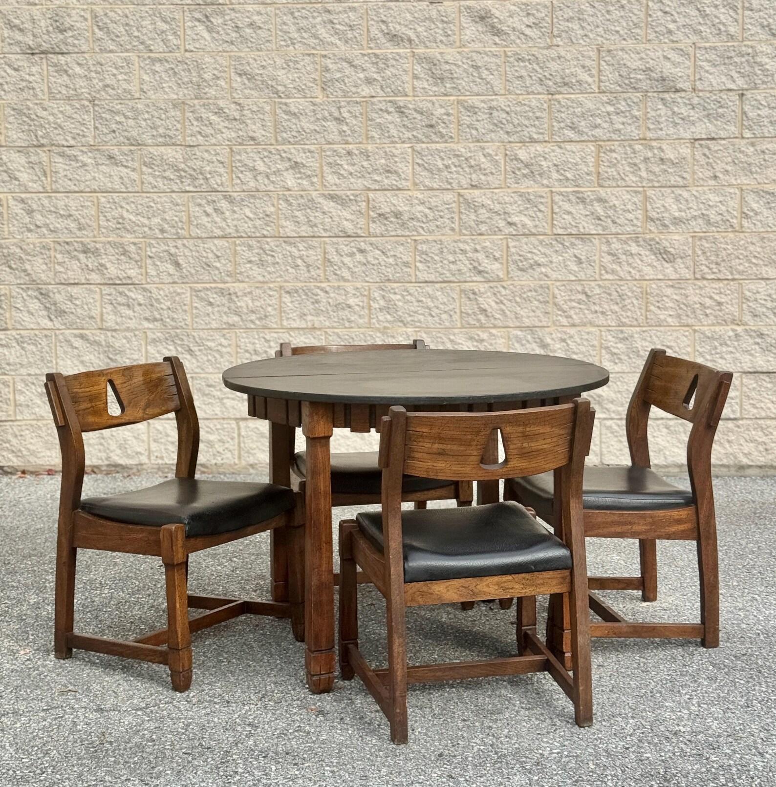 The round dining table features a rustic Spanish-inspired design with a rich walnut-toned finish, decorative apron, and carved leg details. The tabletop is crafted from a softer material, adding a unique texture and finish. 

Dimensions:

The table