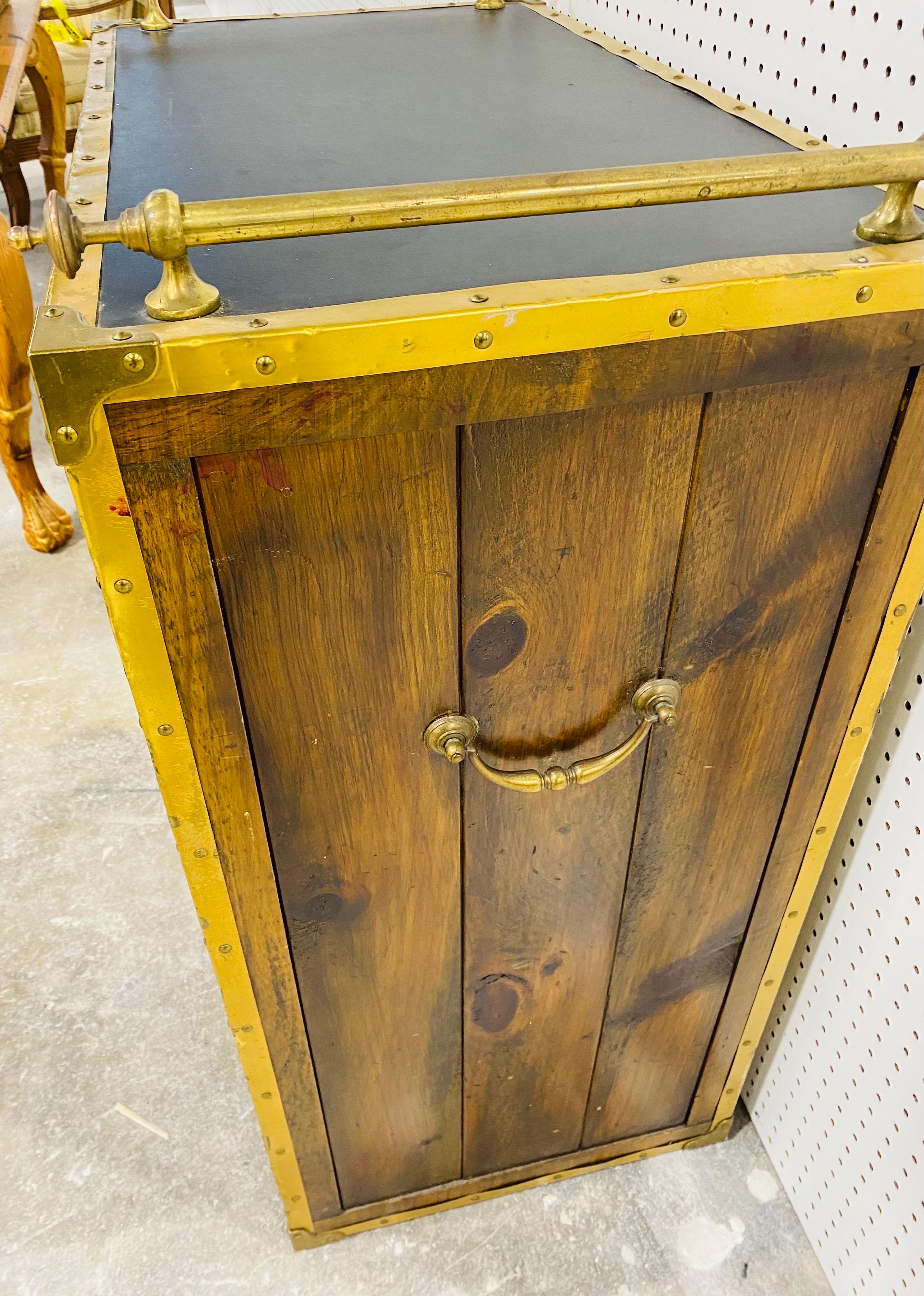 This is a vintage rustic two door stained glass cabinet by Habersham. This cabinet features two doors that have stained glass panels with two drawers at the top. The cabinet features brass details at the top with brass handles on either side. This