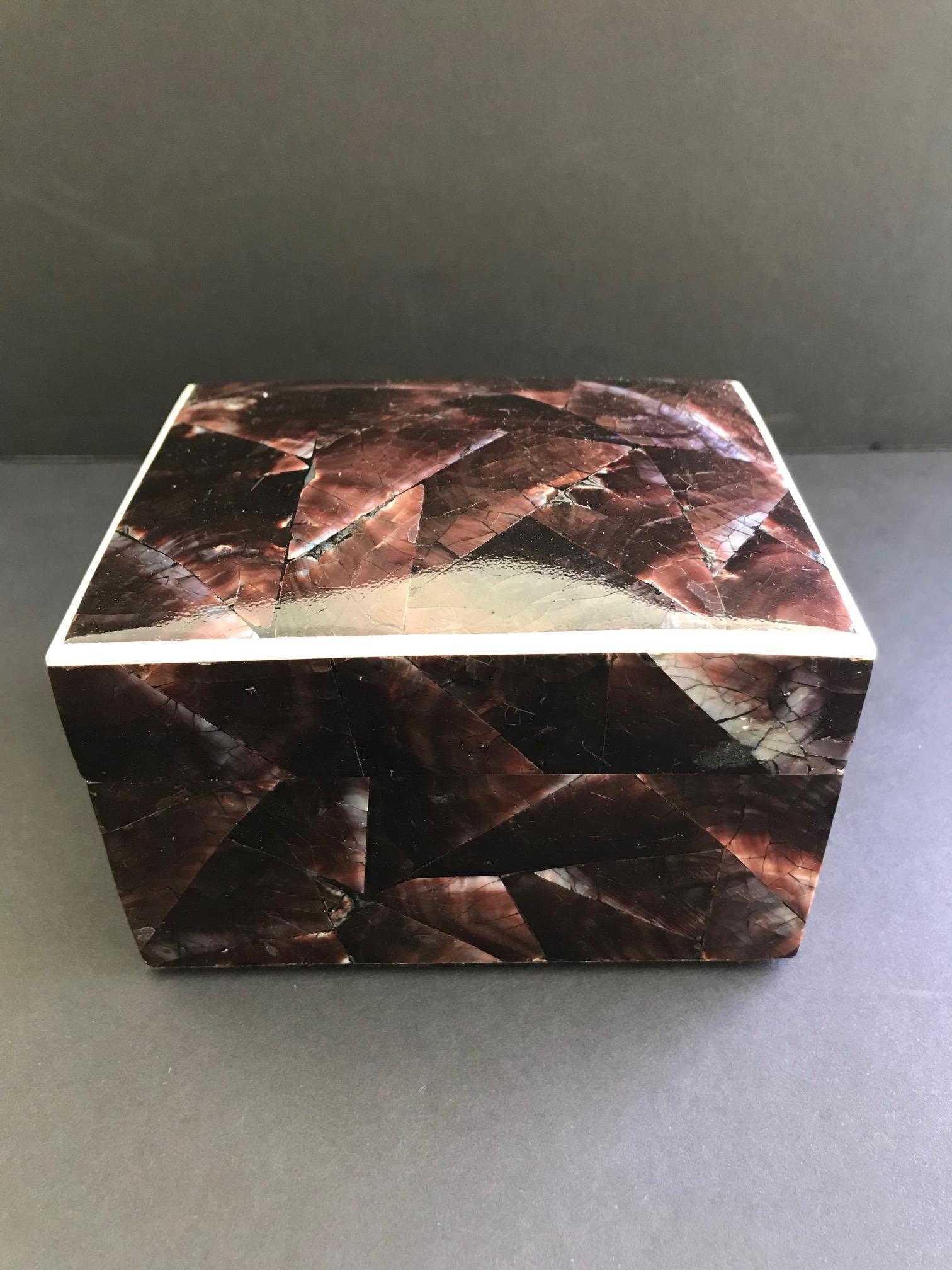 Organic modern decorative box or jewelry box comprised of natural pen shell. The luminous iridescent shells have a mosaic pattern in hues of brown and aubergine. Lid features a contrasting exotic bone trim and opens to reveal a palm wood interior.