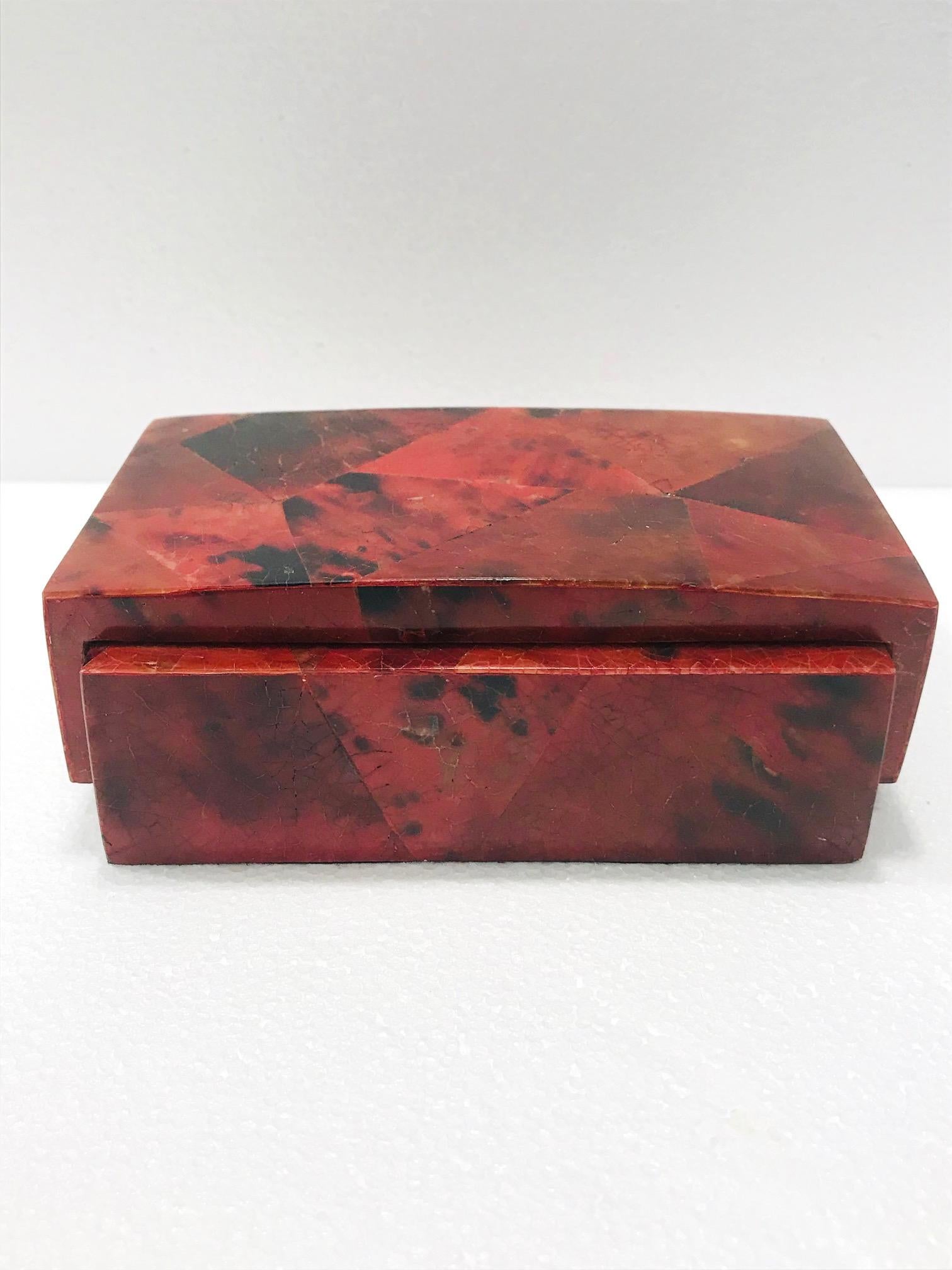 Organic modern desk accessory, lidded box, or jewelry box by R&Y Augousti. All handcrafted in exotic materials featuring lacquered and hand dyed pen-shell over a wood frame. The box features mosaic shell inlays in beautiful hues of red and black.