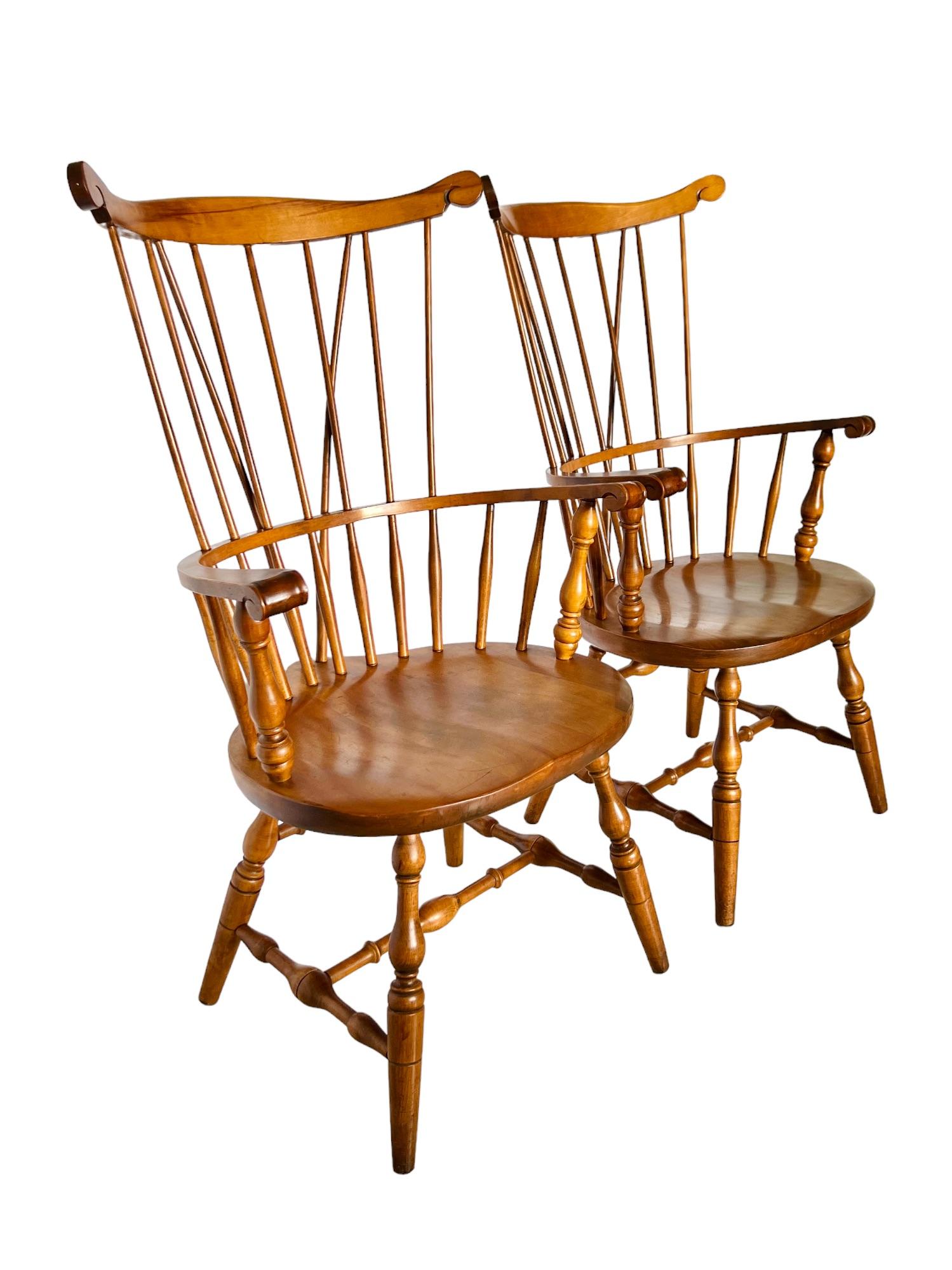 A vintage pair of comb back solid wood Windsor armchairs made by S. Bent & Bros in the early to mid 20th century. Exceptionally hand crafted entirely of maple they feature high braced backs, shaped seats, finely carved and turned details and a