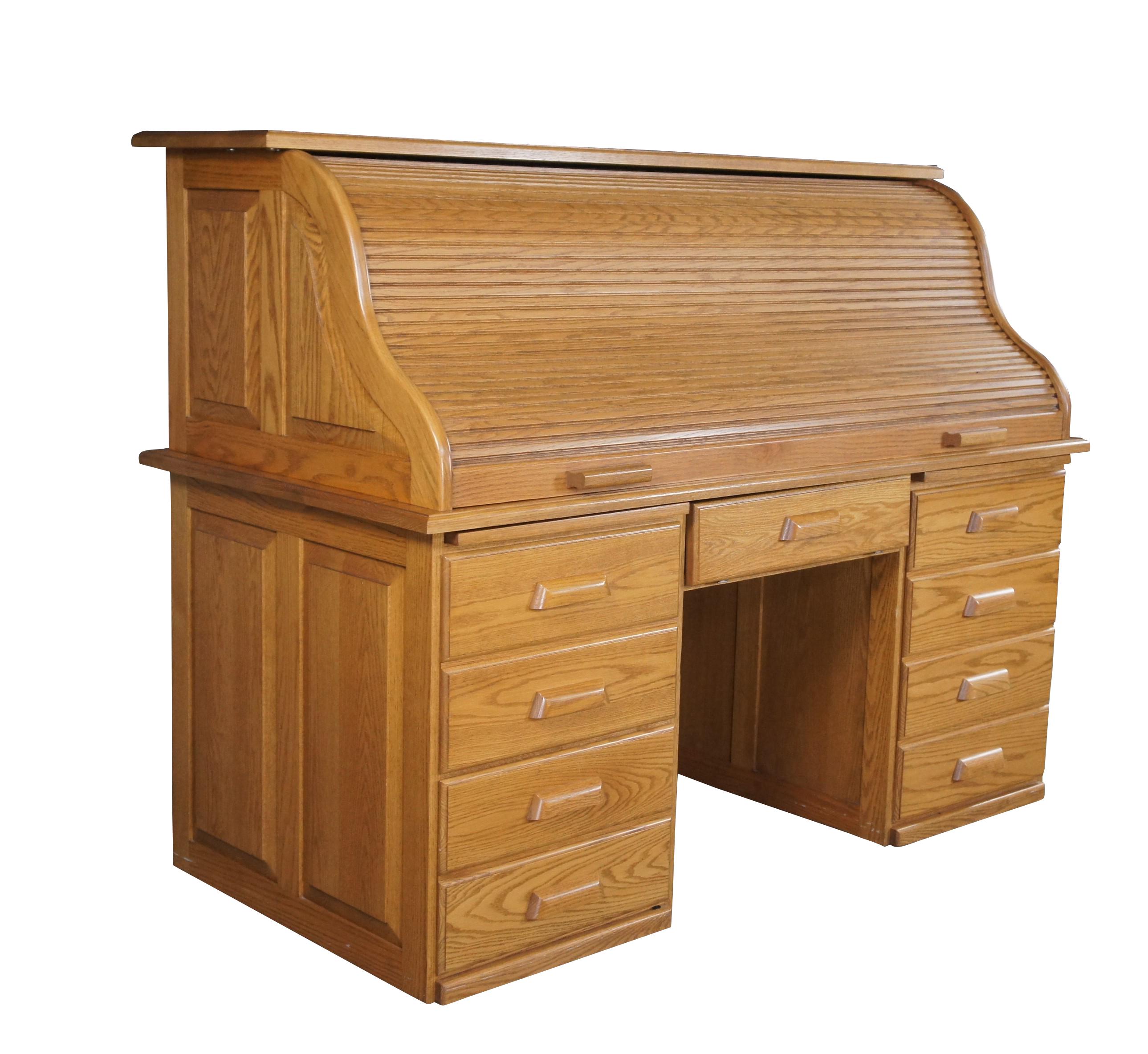 Vintage Oak roll top office or library desk.  Features a S curve serpentine tambour roll top that opens to a work surface with cubbies / index / file and letter storage, supported by a double pedestal base and central keyboard drawer.

Dimensions: