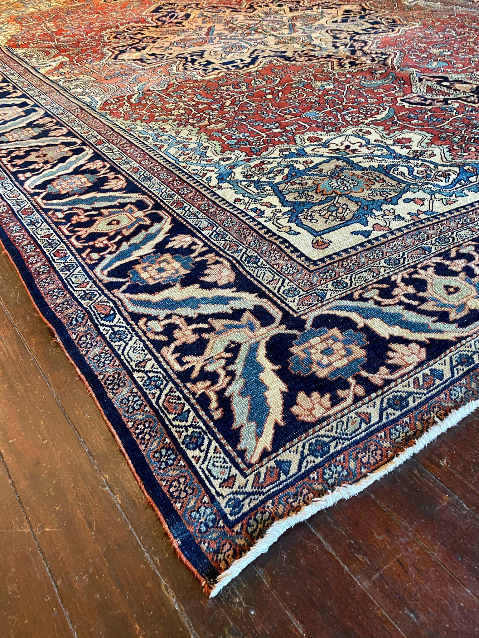 The dominant color in this Vintage S Farahan Rug is a deep, rich navy blue. This deep blue serves as the backdrop for the rug's intricate patterns and motifs, lending a sense of regality and sophistication to the overall design. It creates a
