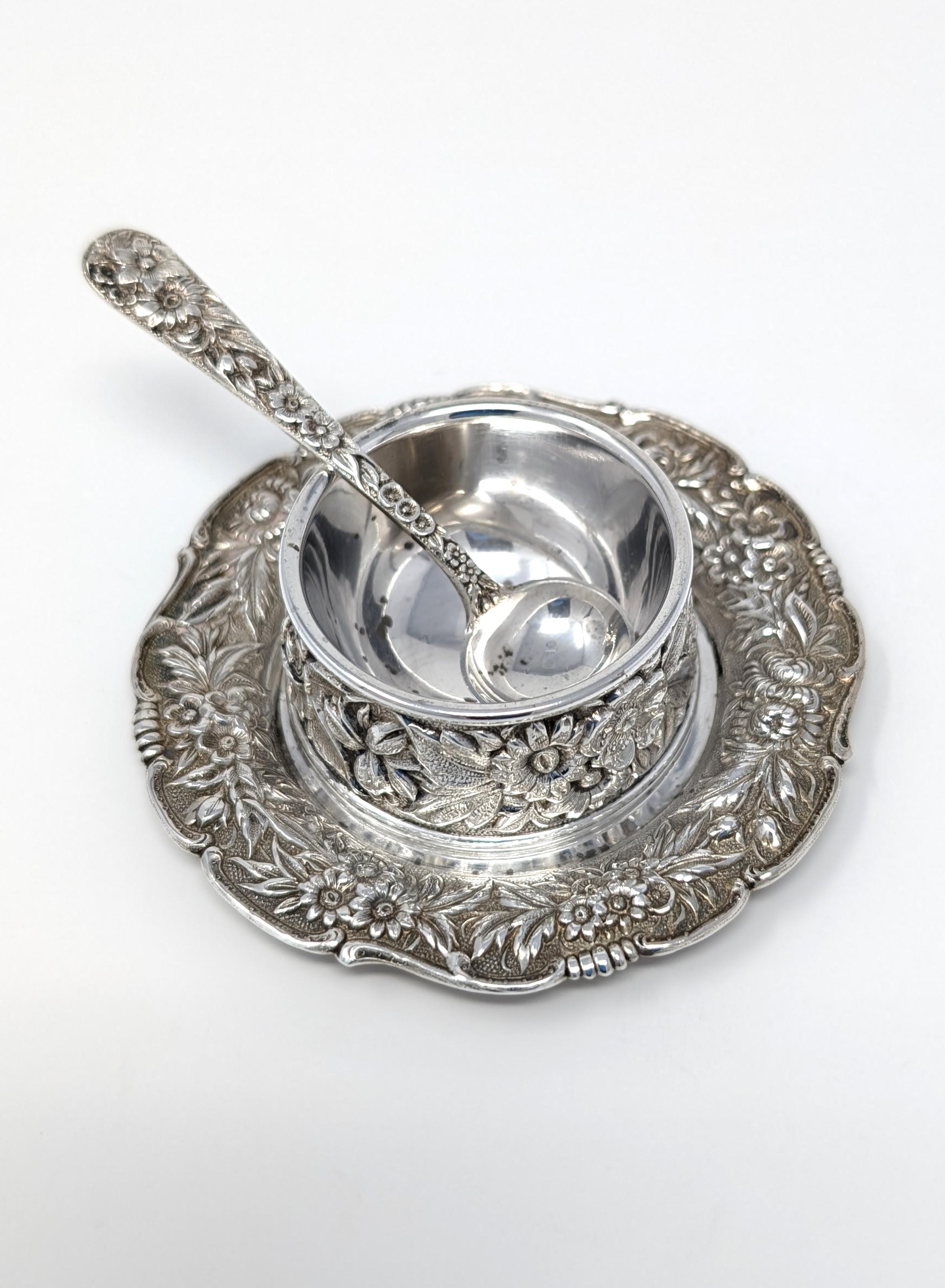 Vintage to antique repousse set in 925 sterling silver by S. Kirk & Son. Featuring a sterling silver salt cellar, salt spoon, and small under plate. Signed / hallmarked on the bottom of each piece. The small cellar plate measures 3.25 inches in