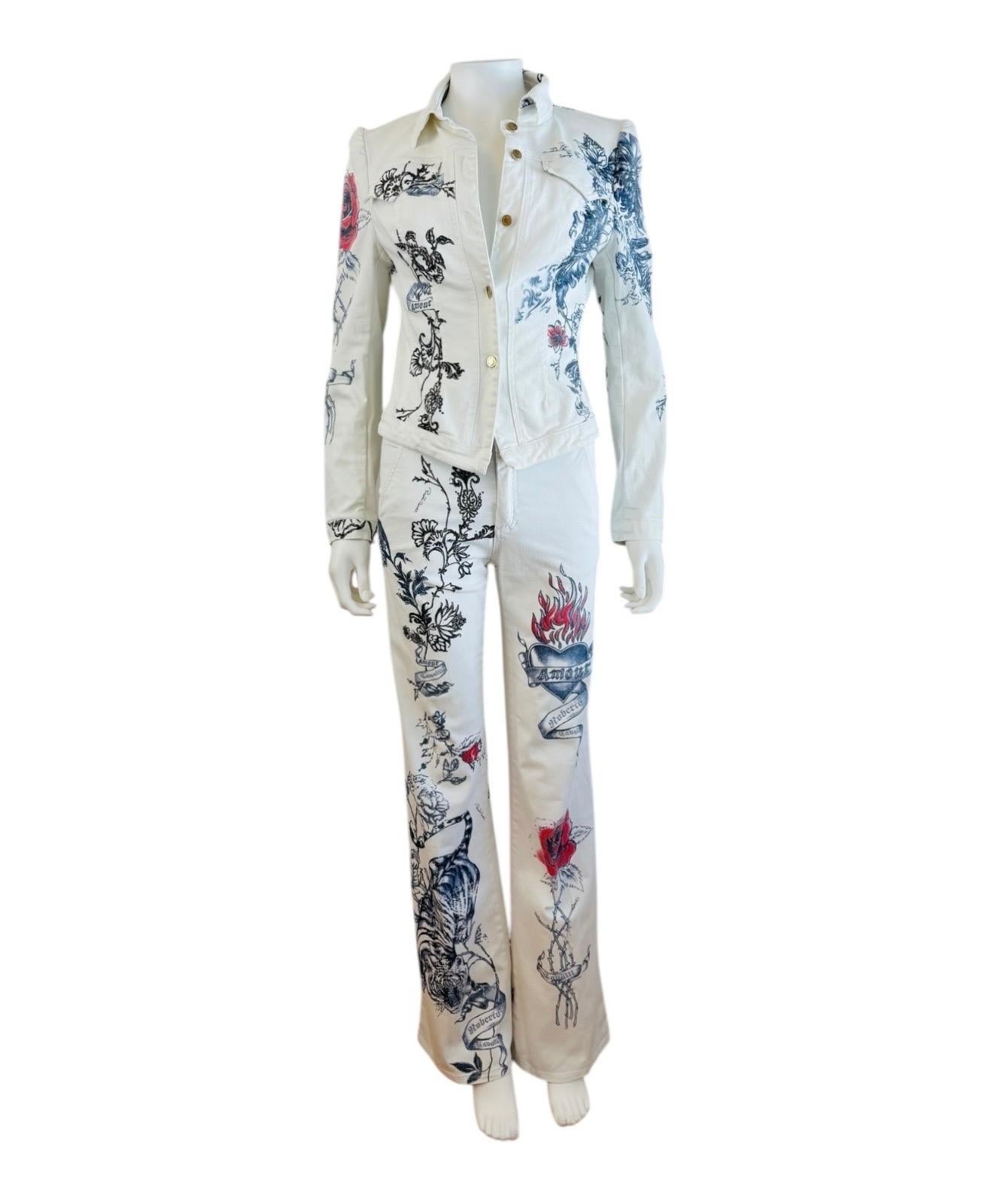 Fabulous S/S 2003 Roberto Cavalli Jacket + Matching Pants
Iconic tattoo print
White stretch cotton fabric with blue + red print + silver glitter paint accents
Jacket has collared neckline
2 pockets on the front
Tailored fit
5 logo gold tone buttons