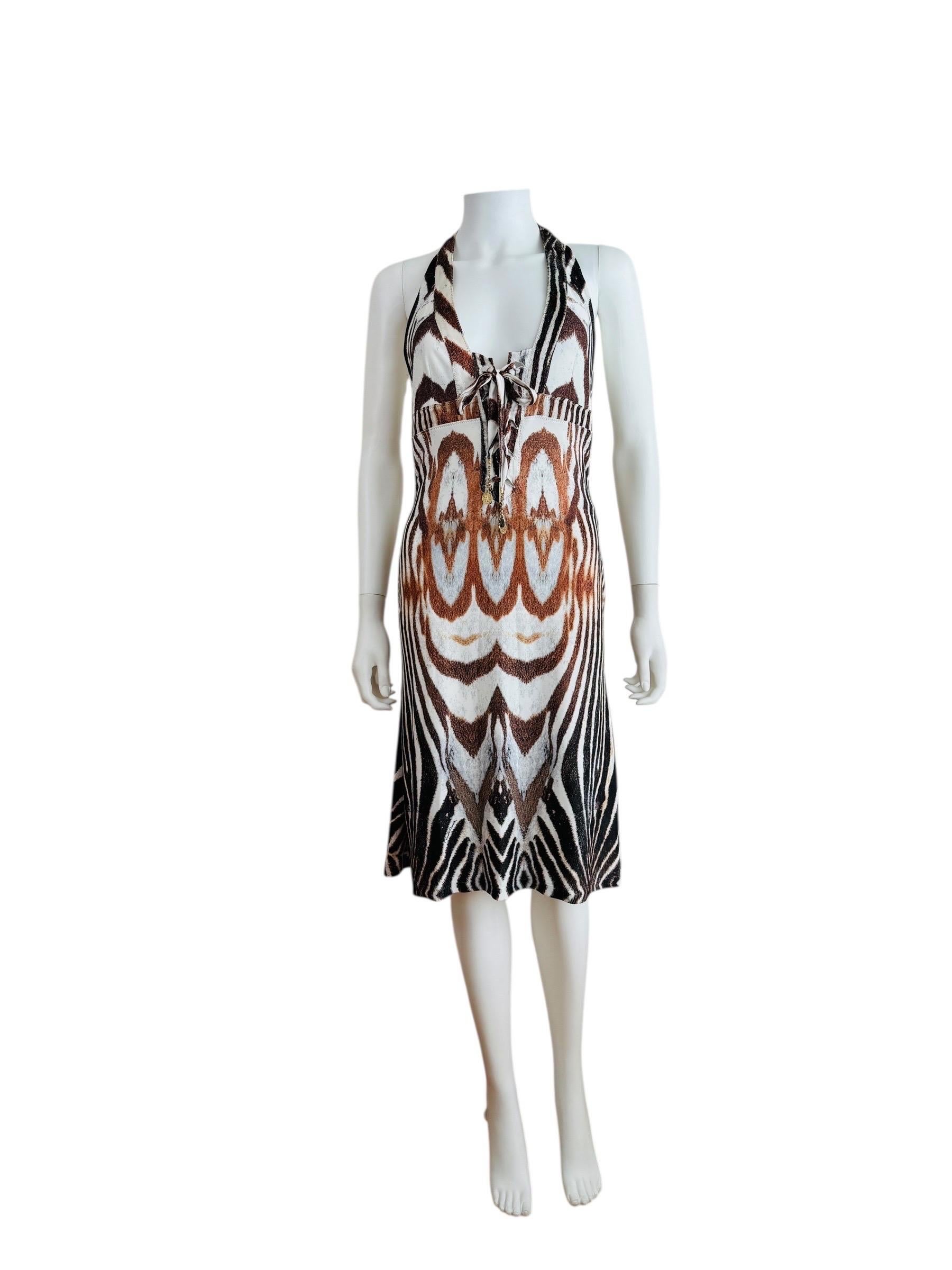S/S 2004 Roberto Cavalli Dress
Animal print elastic + nylon fabric
Halter style neckline with hooks at the back of the neck
Fitted bust with lace up detail up the bodice + at the bust
Long silk ties with Cavalli stamped charms + medallions
Gold