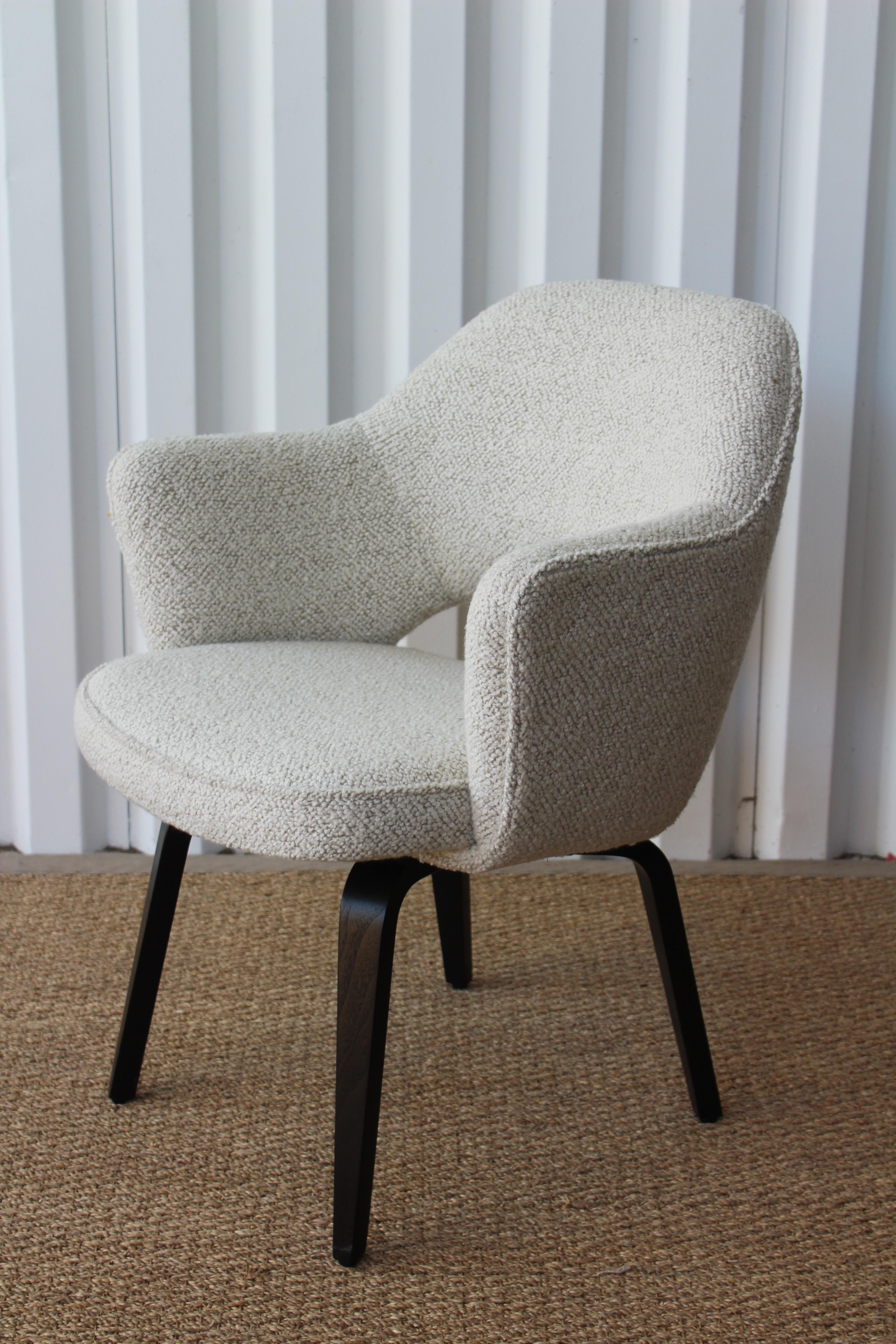 Early vintage armchair designed by Eero Saarinen for Knoll, 1950s. This chair has been completely restored and reupholstered in a soft Italian wool bouclé. The bent walnut legs have been refinished in a satin black finish.