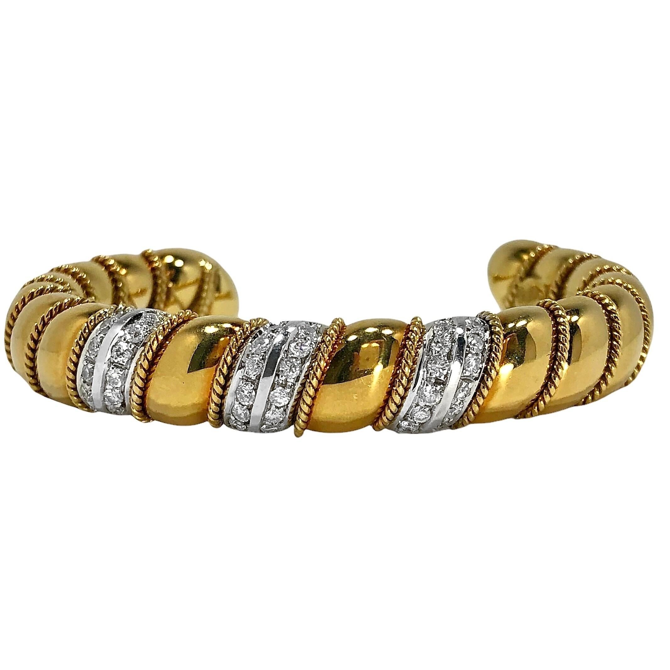 This lovely Late-20th century Sabbadini, flexible bangle bracelet is comprised of repeating slightly puffed links, each edged with delicate gold rope and with three white gold links at the center. These are set with 36 brilliant cut diamonds with a