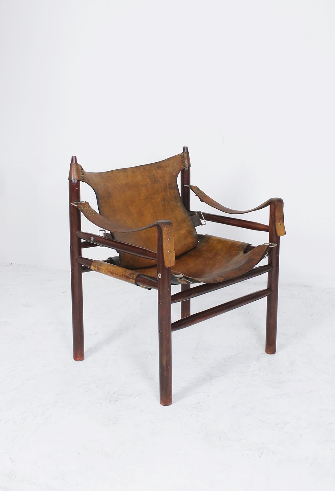 Original and unique vintage Safari chair in the manner of Swedish furniture designer, Arne Norell, from the same period, it was manufactured, circa 1970s in Hungary.

Made of high quality materials, thick leather with beautiful hand-stitching