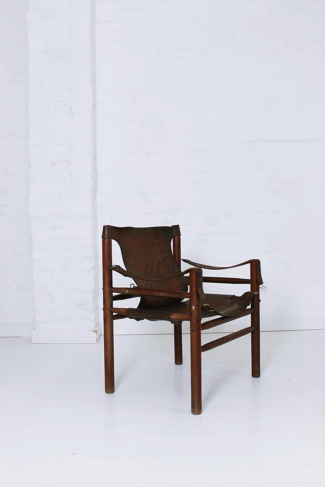 Original and unique vintage safari chair in the manner of Swedish furniture designer, Arne Norell, from the same period, it was manufactured, circa 1970s in Hungary.

Made of high quality materials, thick leather with beautiful hand-stitching