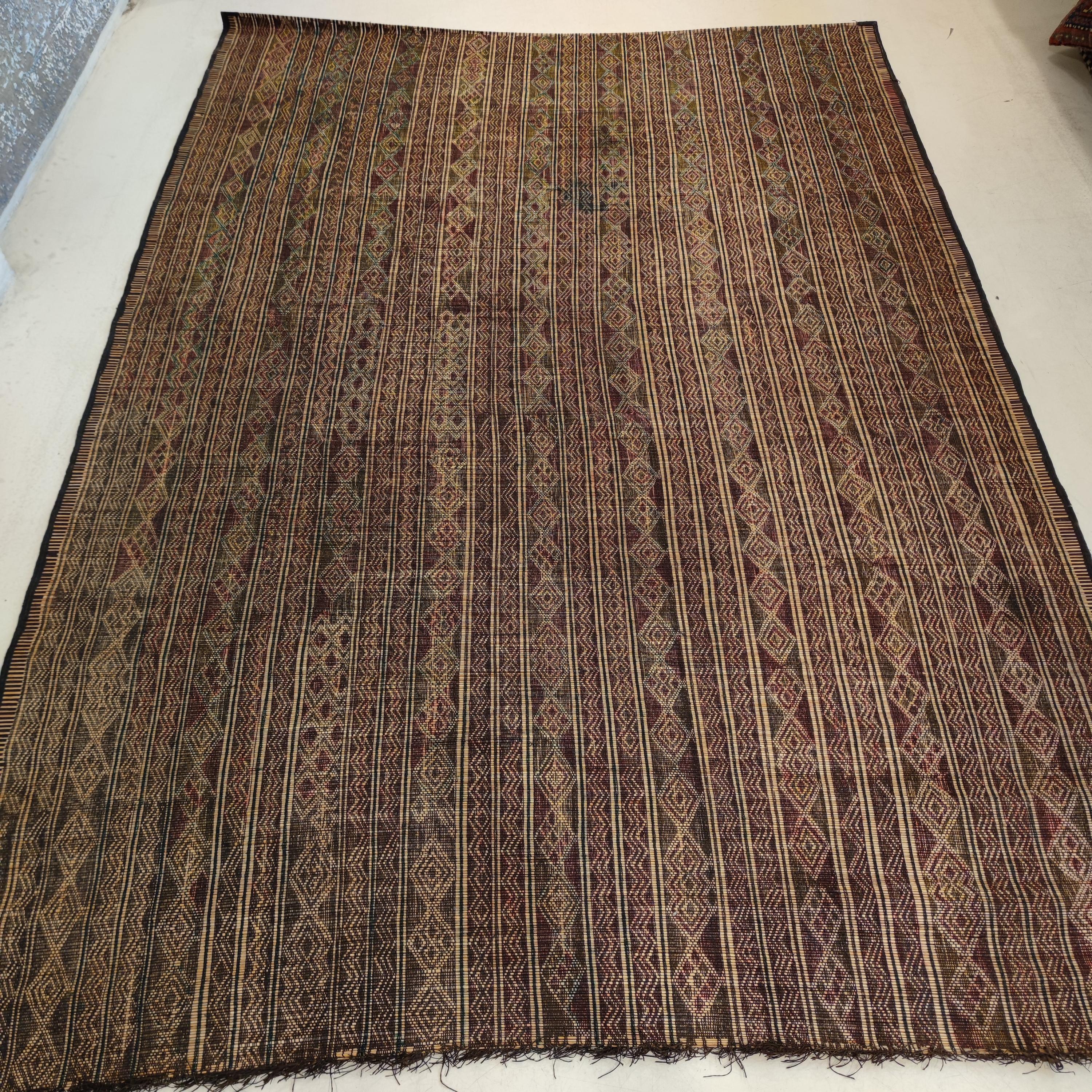The carpets of the Tuareg, who are cattle herding nomads inhabiting a vast expanse of the Sahara desert, are among the most exciting group of weavings to appear on the market. These are woven by binding together fine straw reeds obtained from the