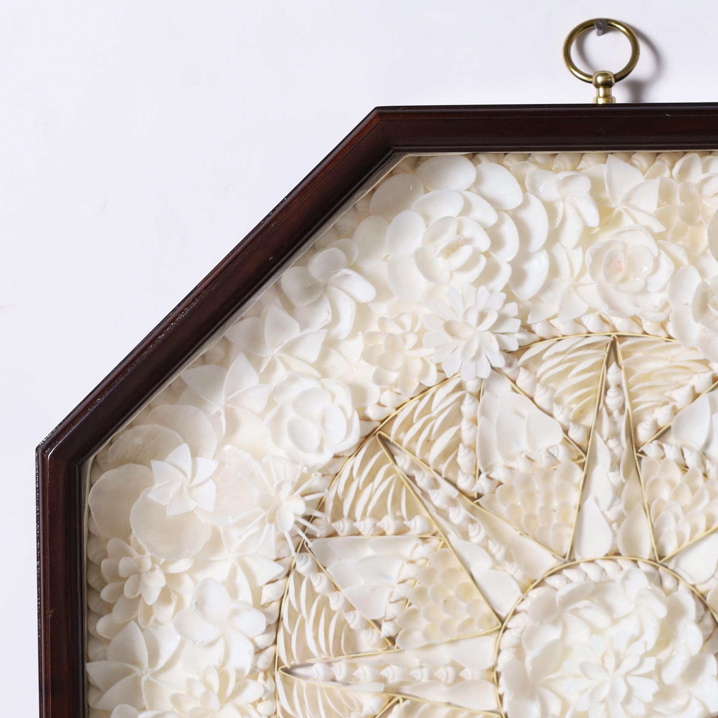 Charming sailor's valentine ambitiously hand crafted with white seashell specimens in star form composition and presented under glass in an octagon shadow box by Authentic Models. 