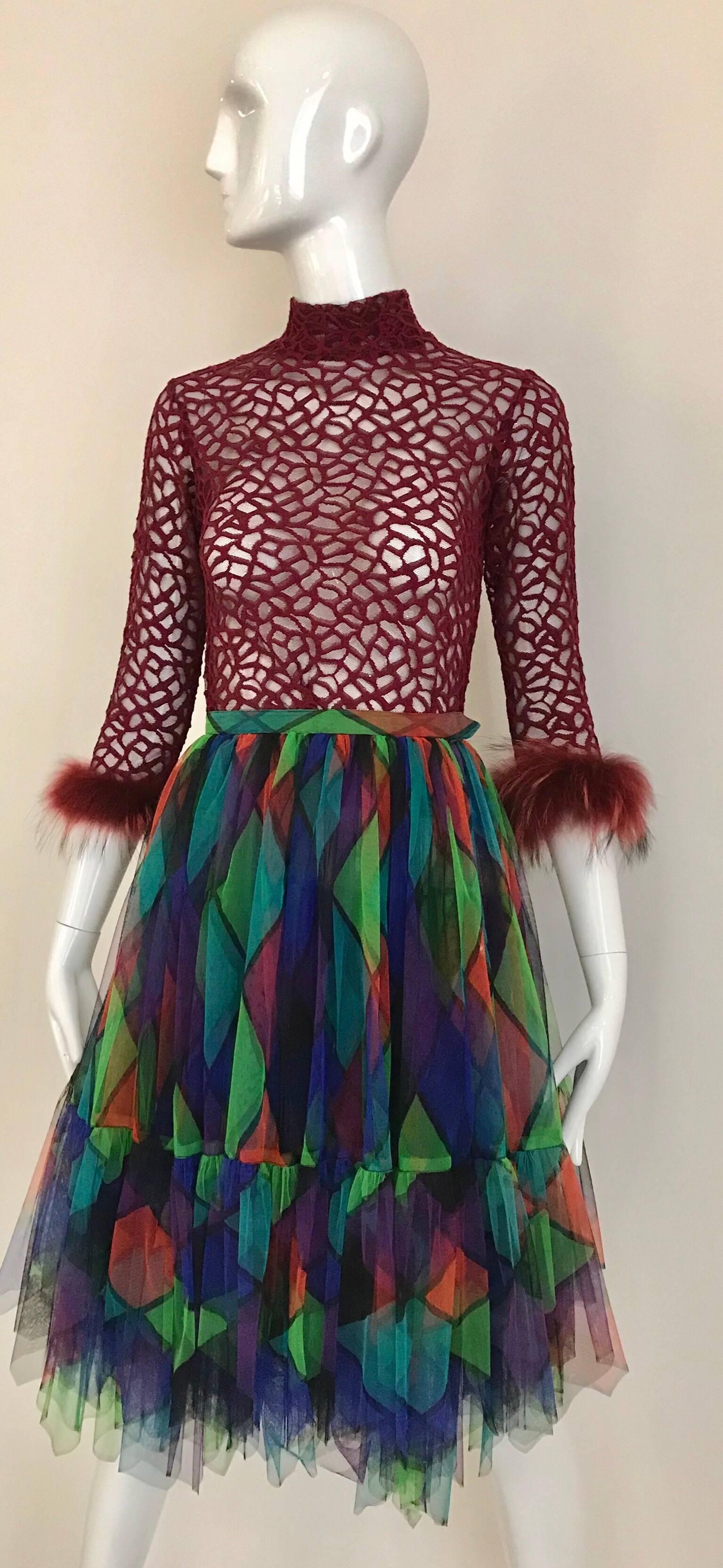 1980s Red, black, green and teal print harlequin tulle mini skirt. Skirt is paired with Jean Paul Gaultier burgundy mesh cropped sweater shirt with ostrich sleeves. ( sweater shirt available for purchase) 
Waist; 24 inches/ skirt length : 26