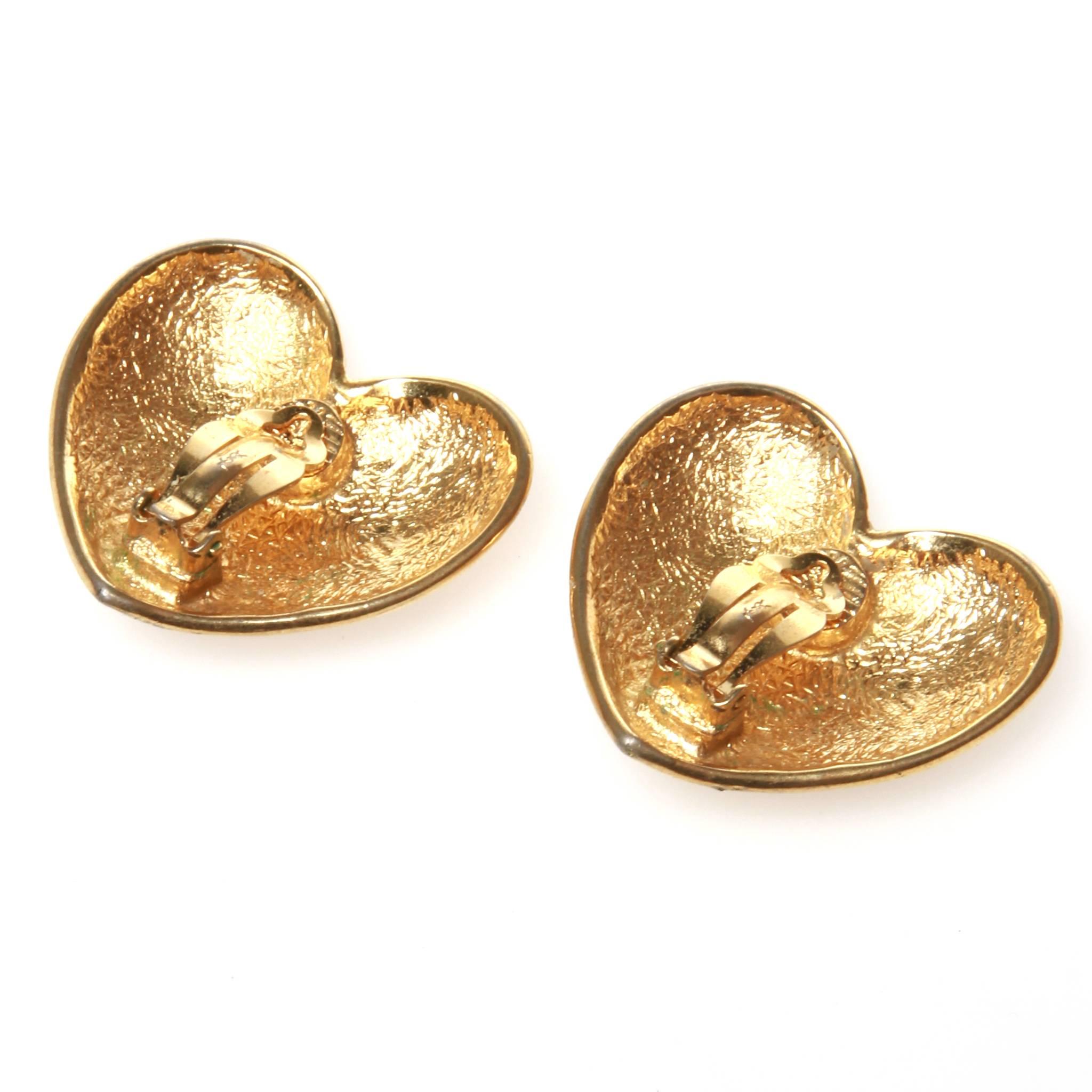 Vintage Saint Laurent YSL clip on earrings featuring a simple love heart design in shiny gold-tone metal. 