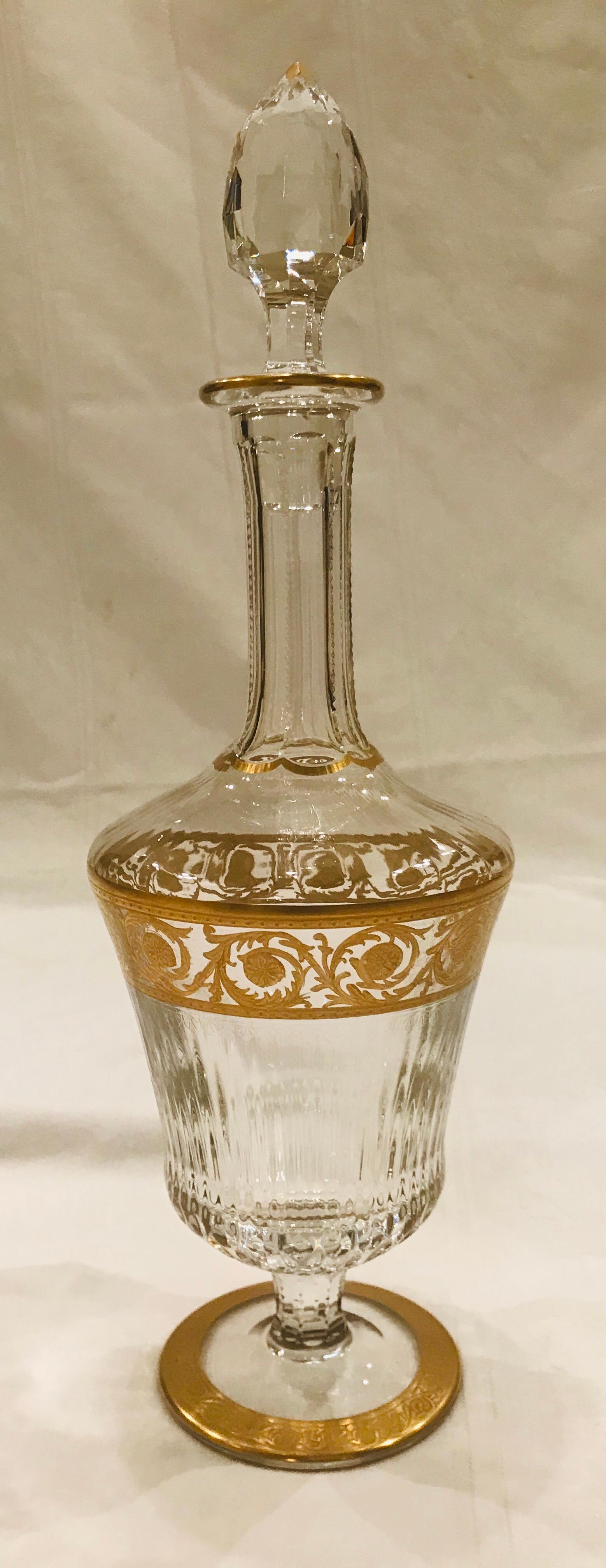 A Classic Saint Louis thistle gold clear faceted wine or cordial decanter.

This mouth blown, faceted and incised glass is heavily encrusted with gold after incising, then re-fired so the gold will not wear.

The decanter is 13” tall by 4”in