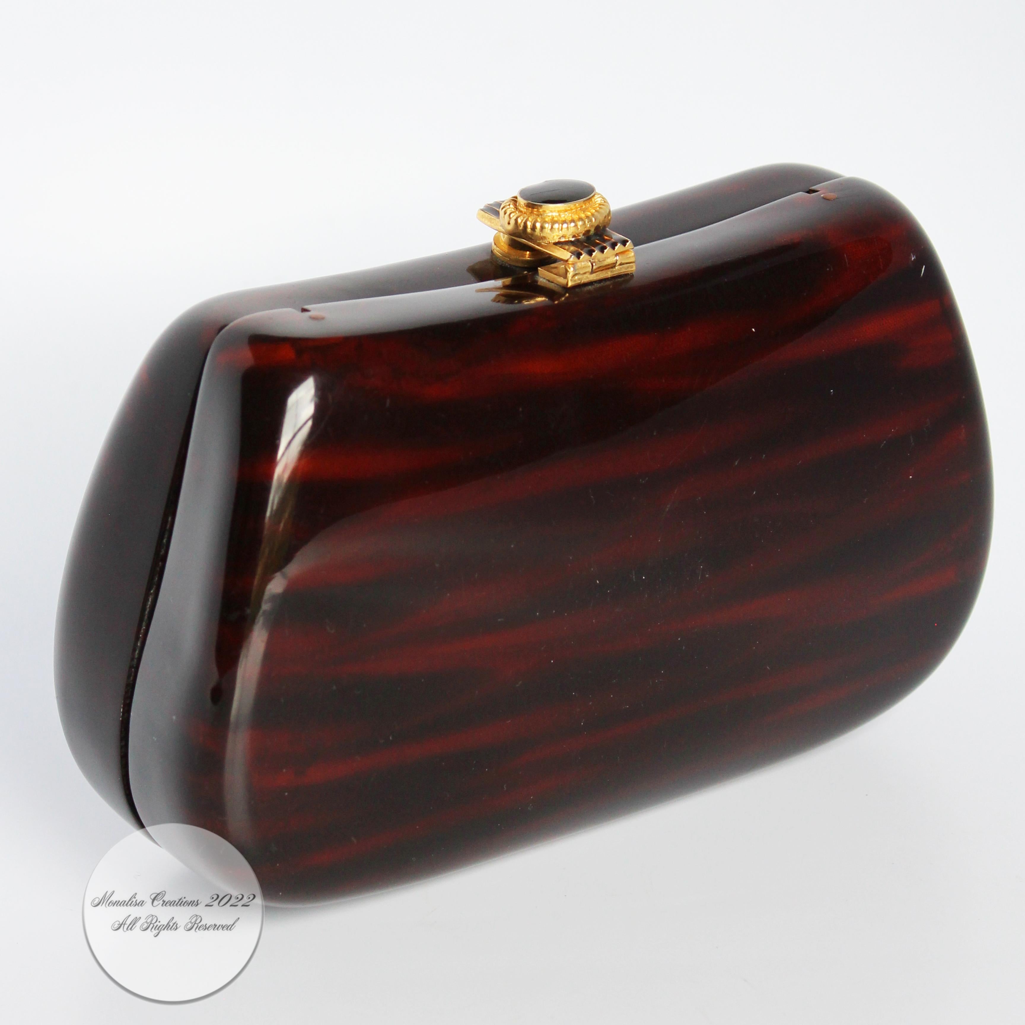 Vintage evening bag or minaudière, made in Italy for Saks Fifth Avenue, most likely in the late 1960s.  Made from polished resin made to resemble wood, it features a decorative gold metal and enamel clasp closure and a gold coil chain that can be